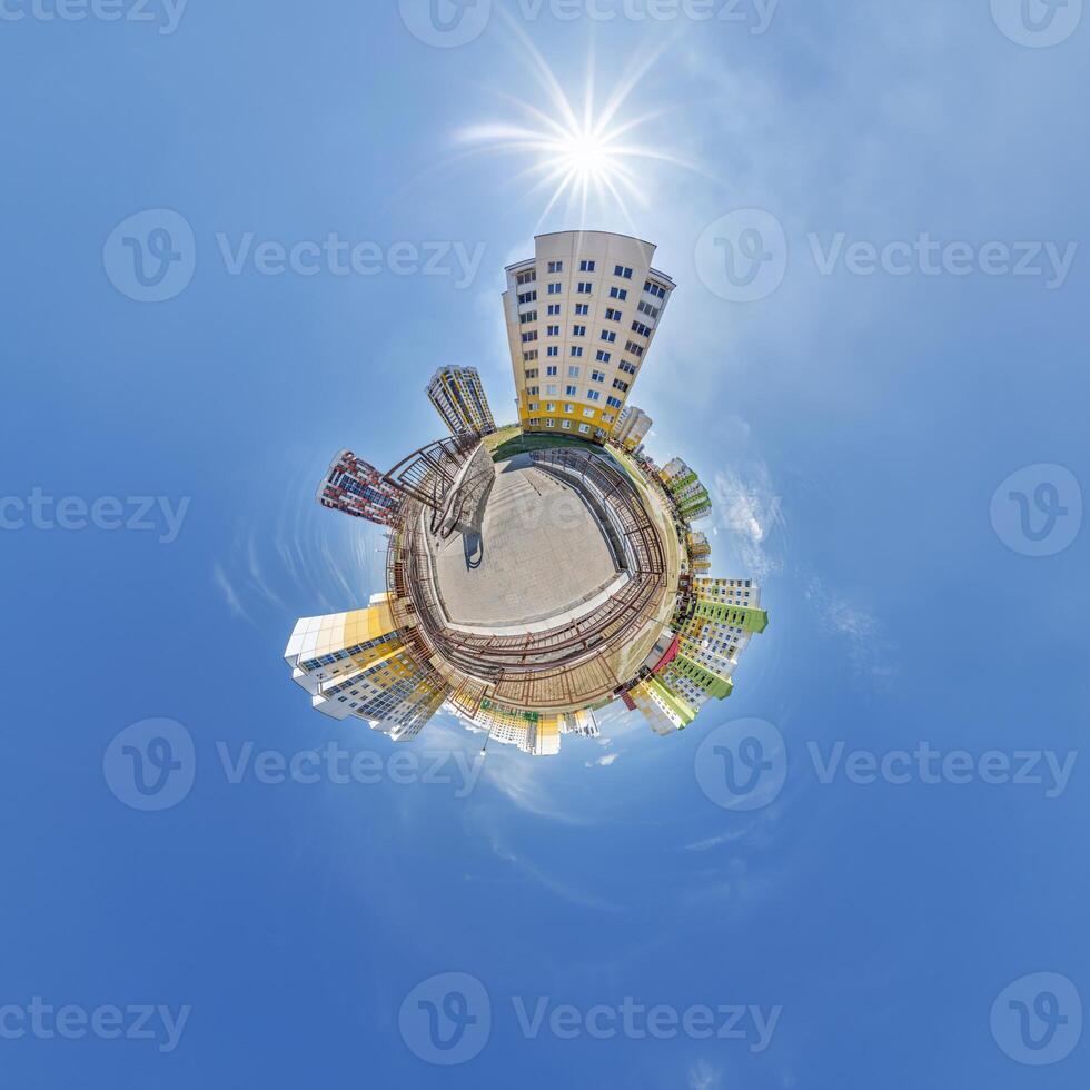 abstract swirling tiny planet spherical panorama of multi-storey buildings of skyscrapers of a residential complex in the form of a butterfly, bugs, crabs in blue sky photo