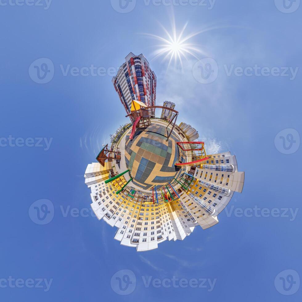abstract swirling tiny planet spherical panorama of multi-storey buildings of skyscrapers of a residential complex in the form of a butterfly, bugs, crabs in blue sky photo