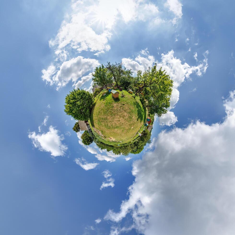 simple little tiny planet without buildings in blue sky with beautiful clouds. Transformation of spherical panorama 360 degrees. Spherical abstract aerial view. Curvature of space. photo