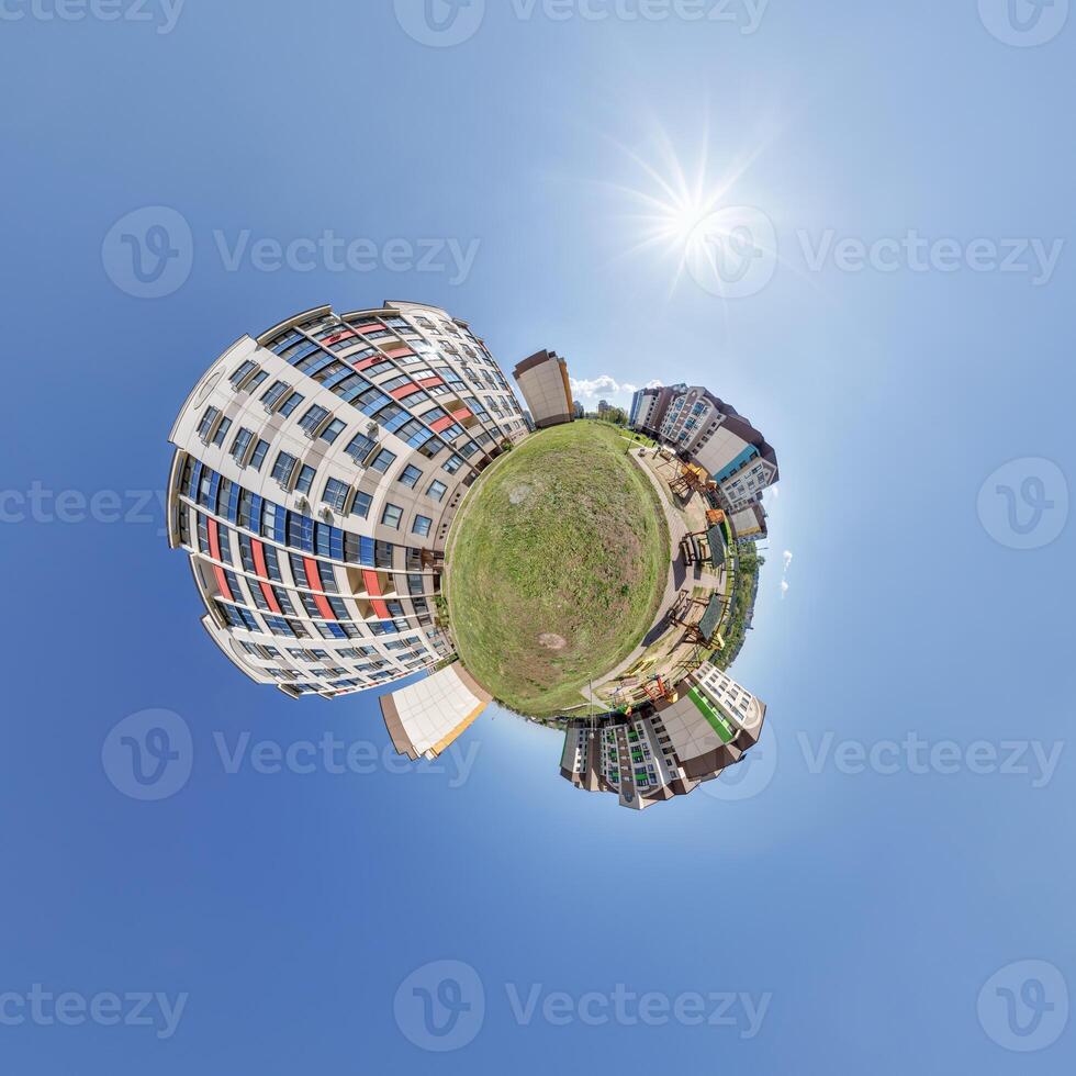 abstract swirling tiny planet spherical panorama of multi-storey buildings of skyscrapers of a residential complex in the form of a butterfly, bugs, crabs in blue sky photo