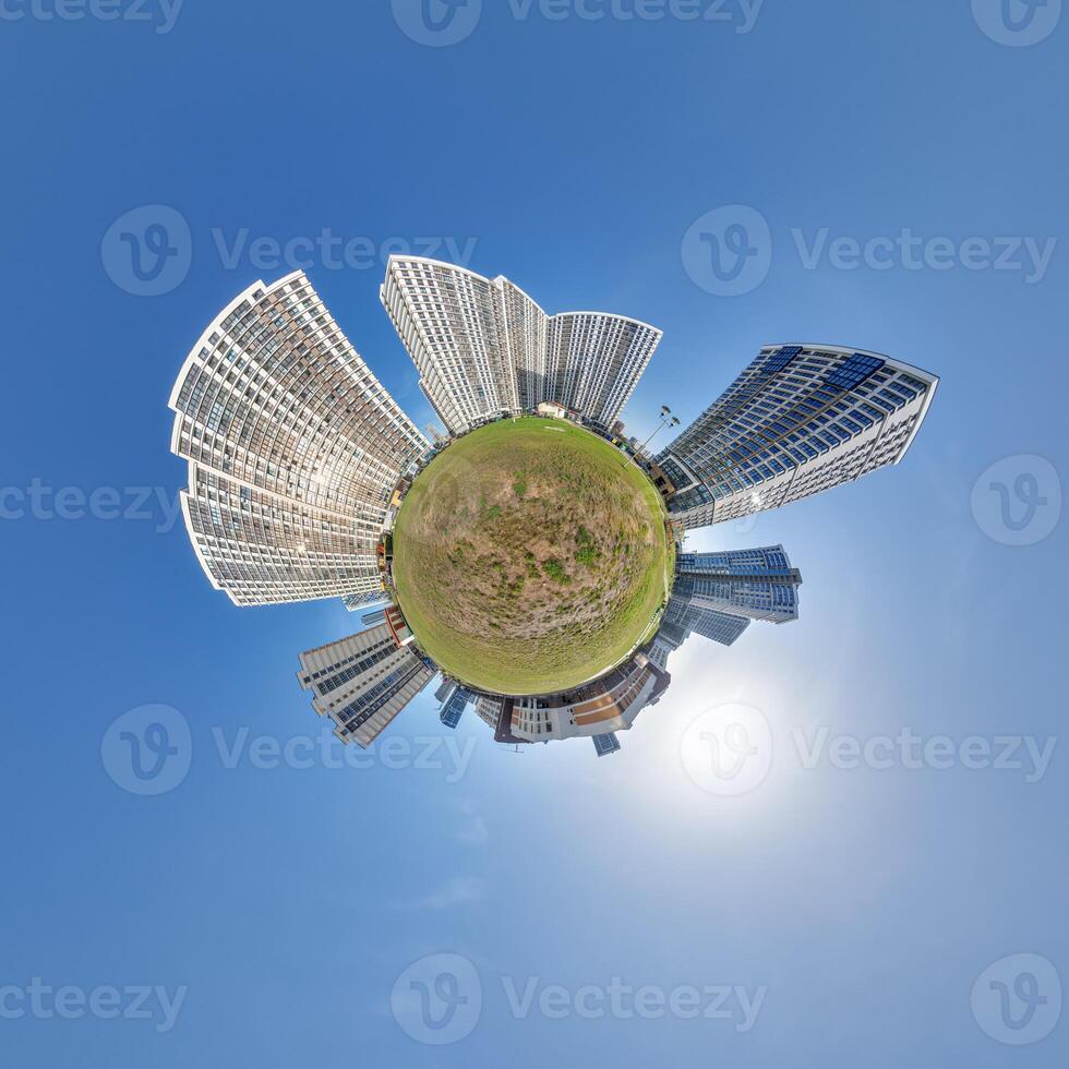 abstract swirling tiny planet spherical panorama of multi-storey buildings of skyscrapers of a residential complex in the form of a butterfly, bugs, crabs in blue sky photo