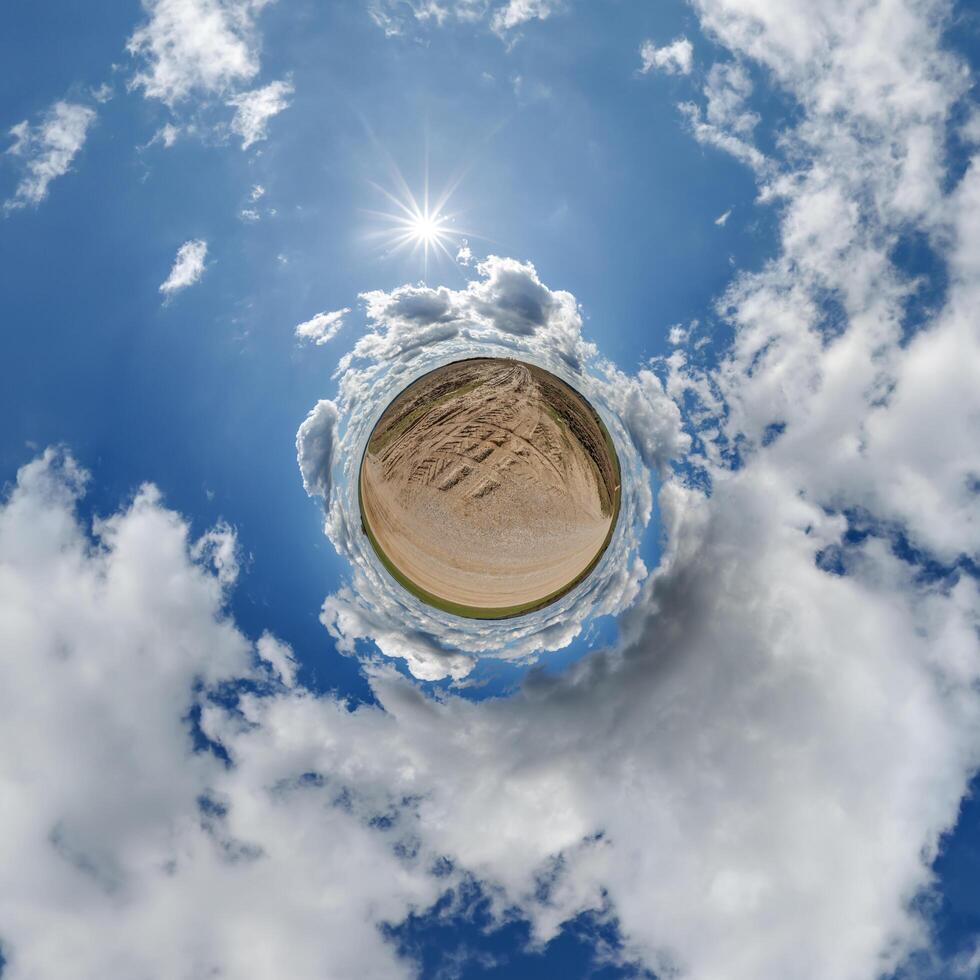 simple little tiny planet without buildings in blue sky with beautiful clouds. Transformation of spherical panorama 360 degrees. Spherical abstract aerial view. Curvature of space. photo