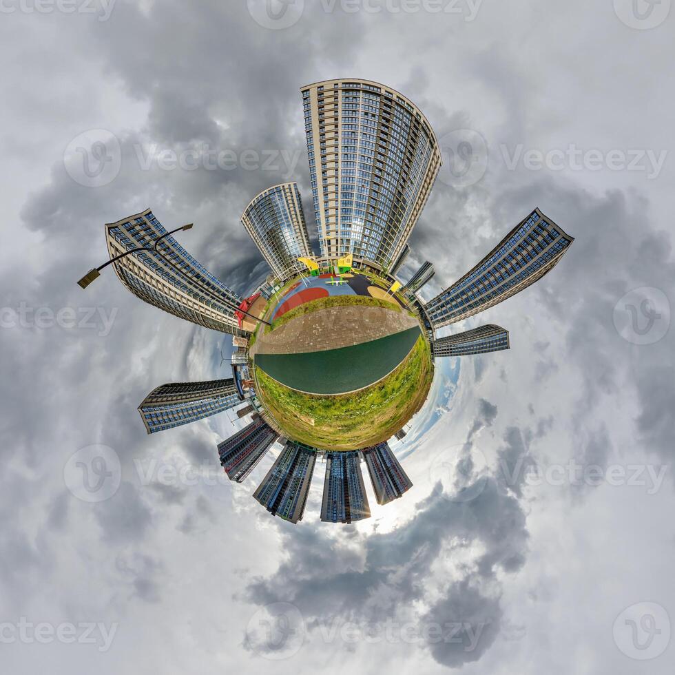 abstract swirling tiny planet spherical panorama of multi-storey buildings of skyscrapers of a residential complex in the form of a butterfly, bugs, crabs in blue sky photo