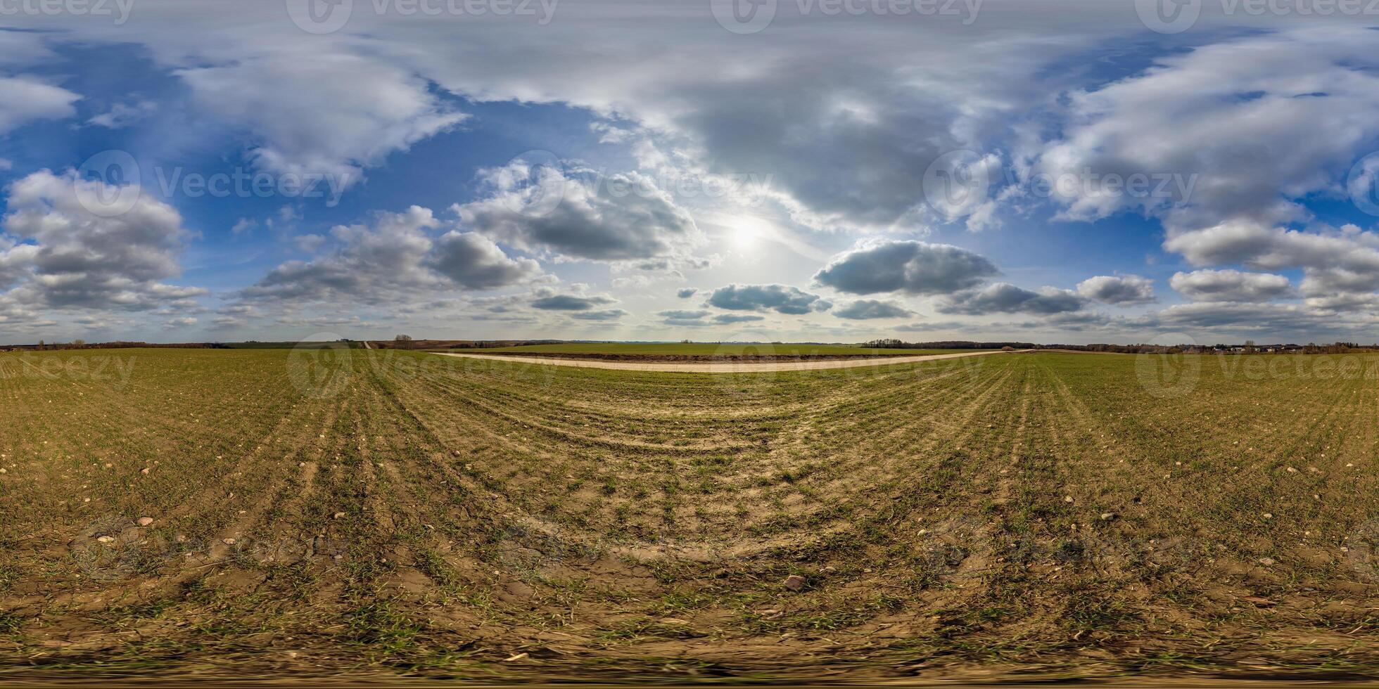 360 hdri panorama view among fields in spring day with beautiful clouds in equirectangular full seamless spherical projection, ready for VR AR or sky dome replacement photo
