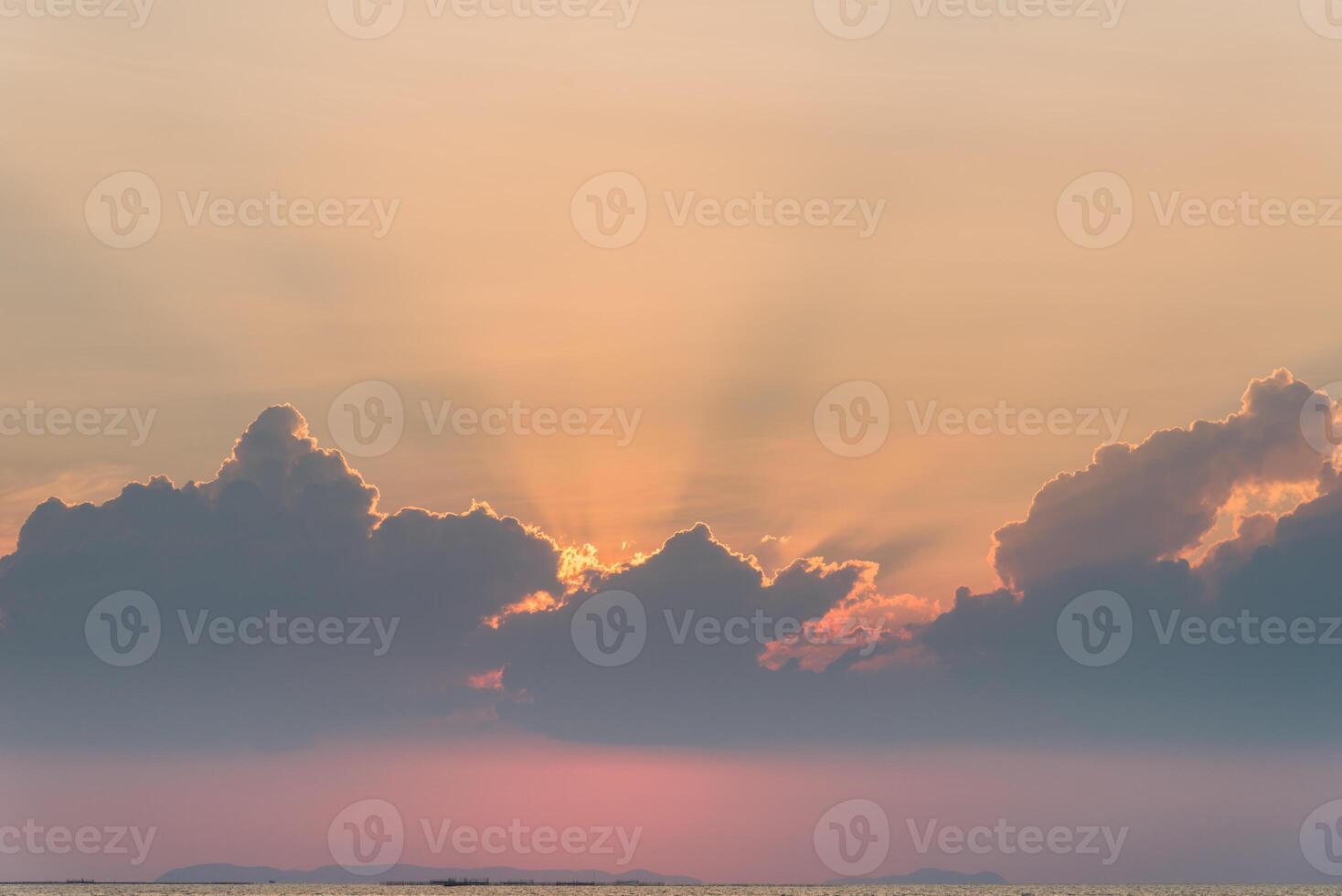 Beautiful dramatic sky clouds with light rays at sunset. Natural landscape for background photo