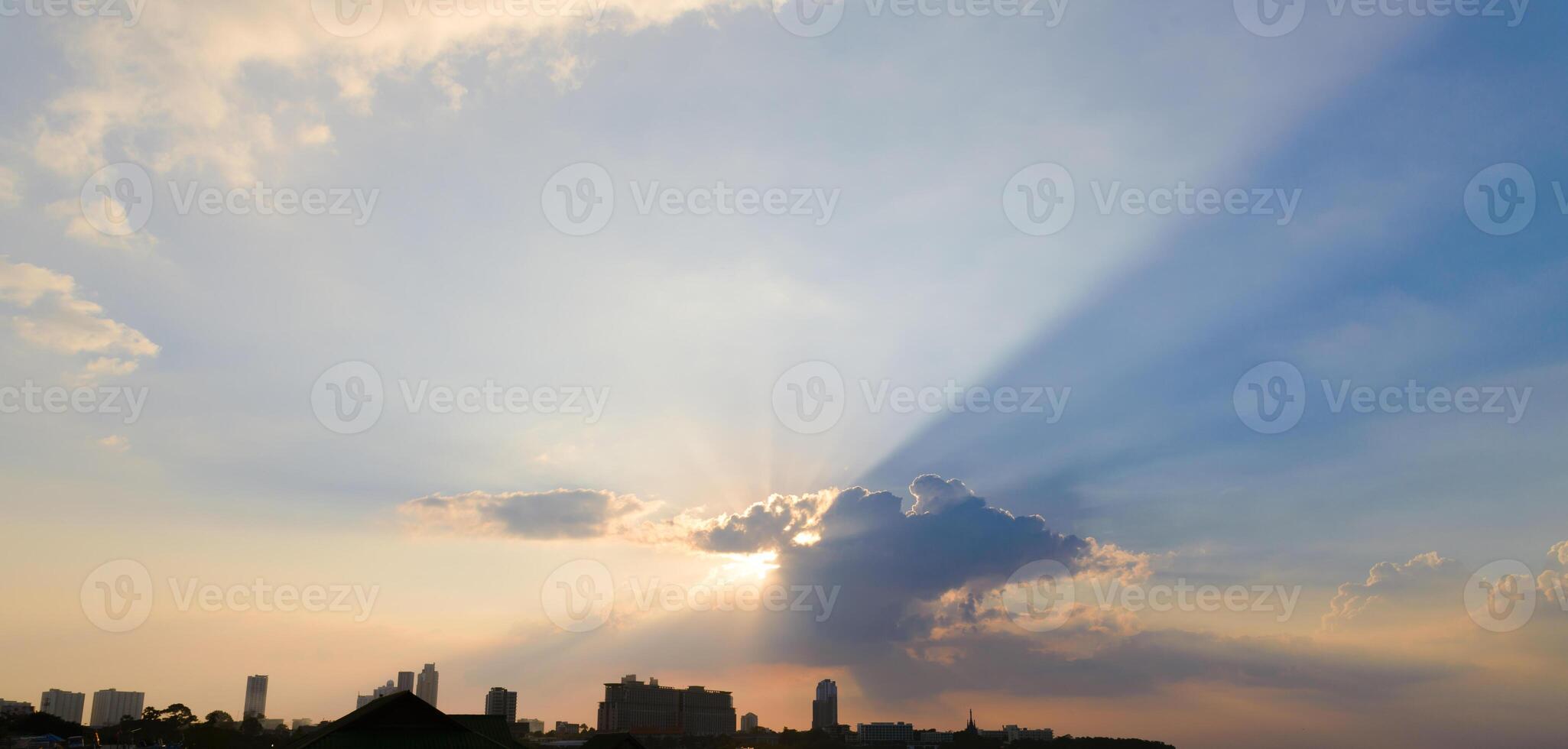 Beautiful dramatic sky clouds with light rays at sunset. Natural landscape for background photo