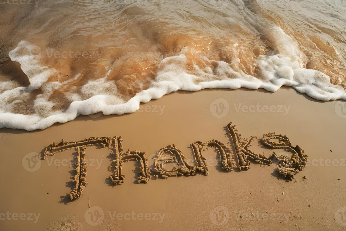 Sandy beach with Thanks written in wet sand, gentle waves, warm sunlight photo