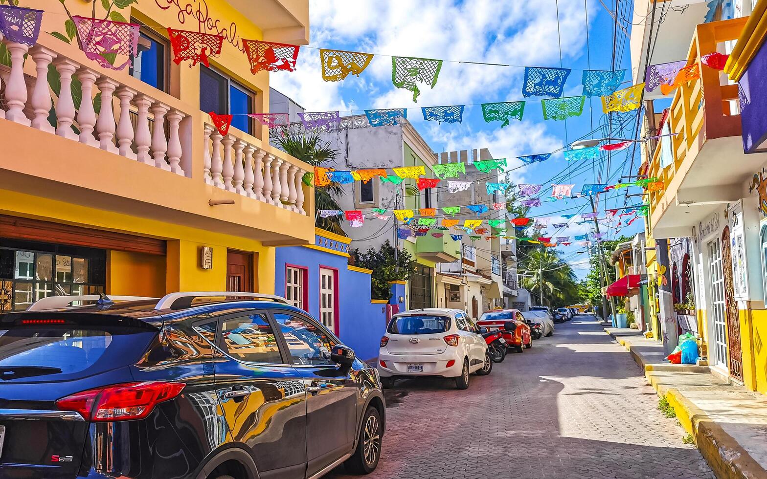 Typical colorful tourist streets sidewalks restaurants stores Isla Mujeres Mexico. photo