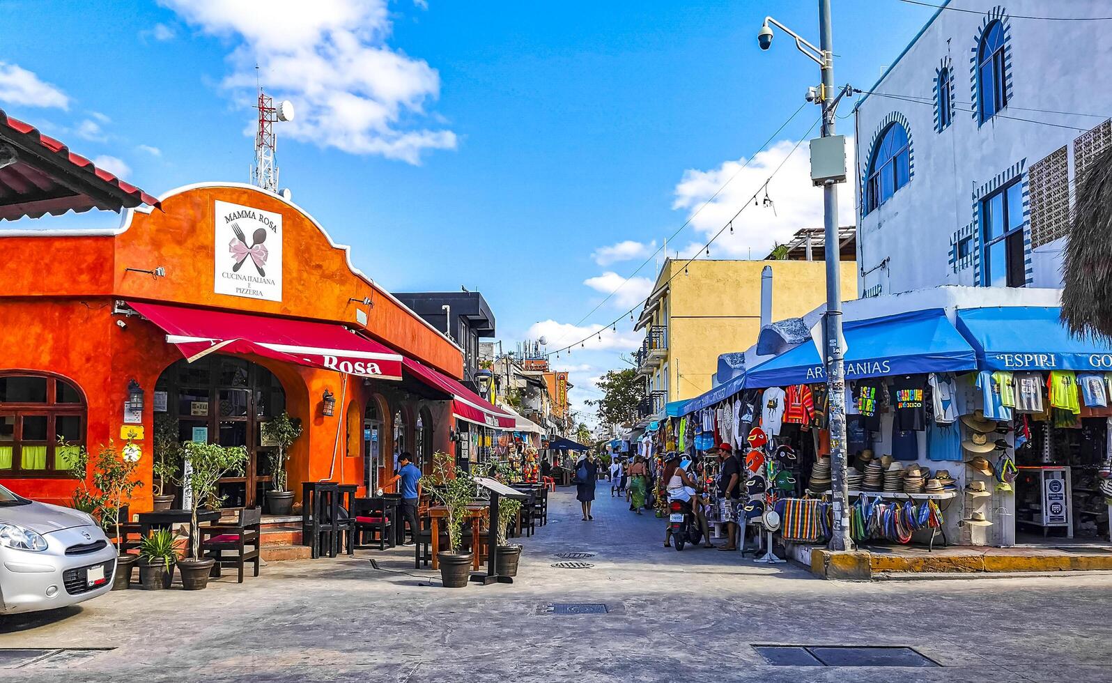 Typical colorful tourist streets sidewalks restaurants stores Isla Mujeres Mexico. photo
