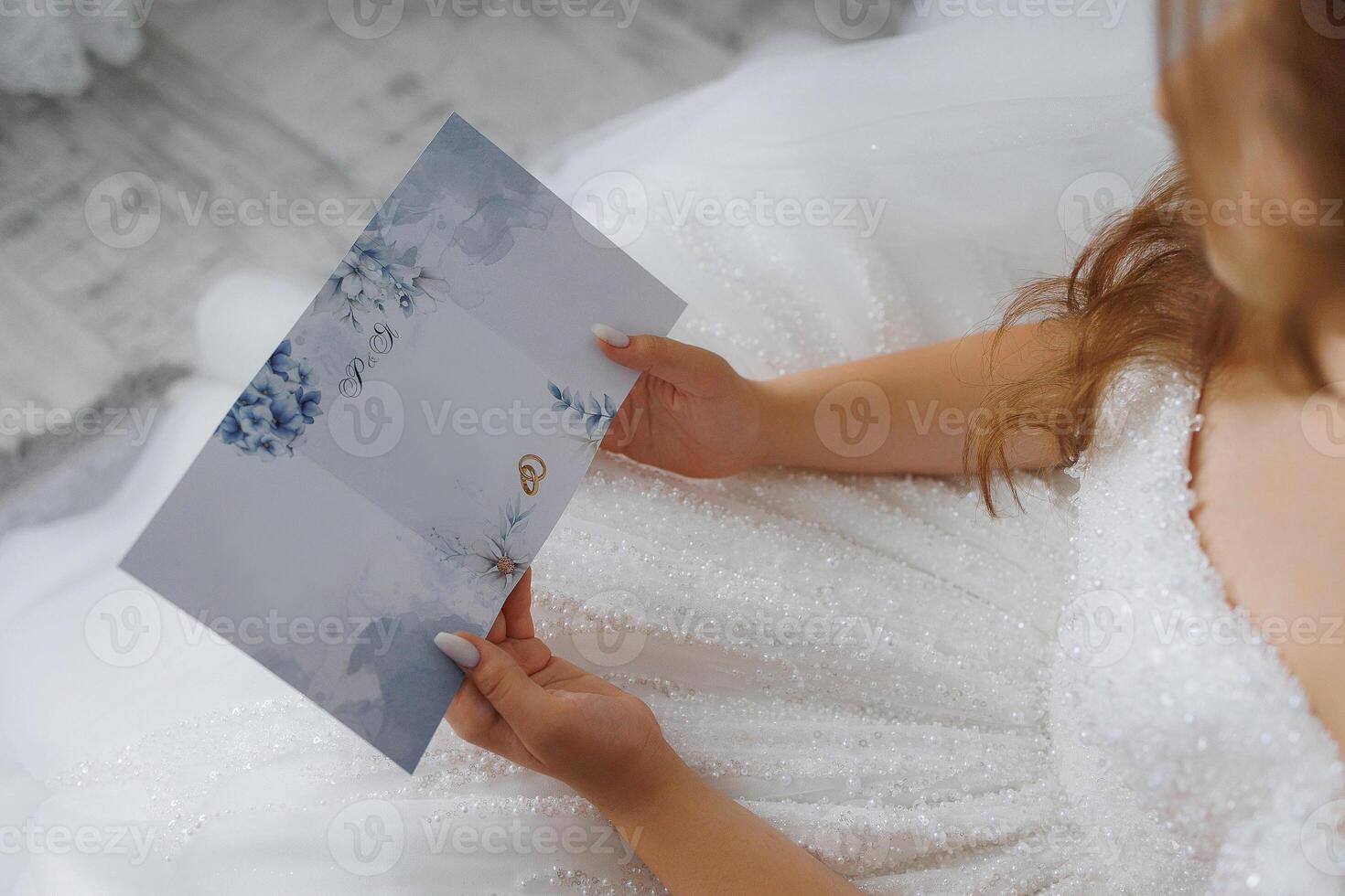 A woman is sitting on the floor holding a blue card with the word on it photo