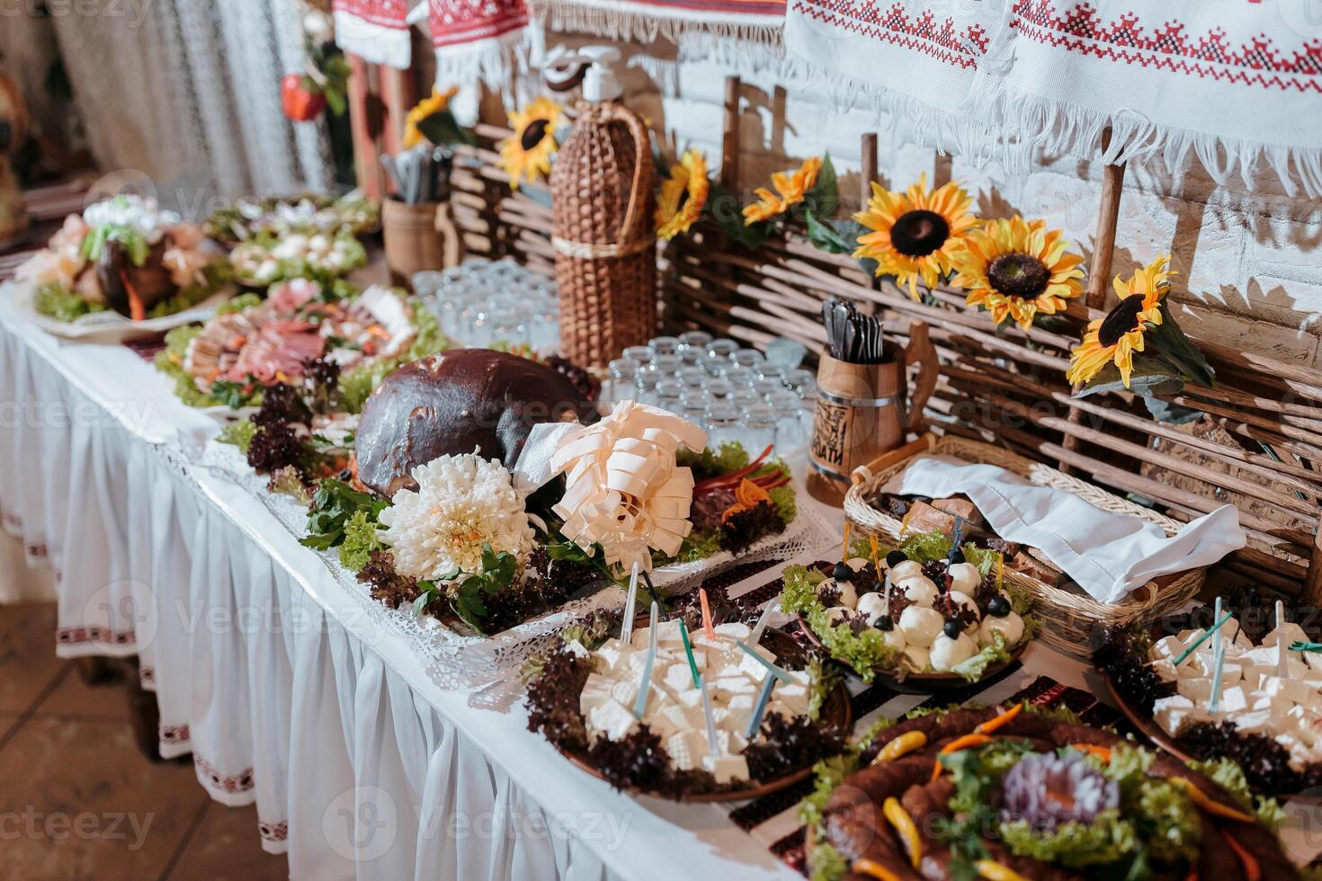 A table is covered with a variety of food, including sandwiches, salads, and desserts. The table is set for a party or gathering, and the food is arranged in a way that is visually appealing photo