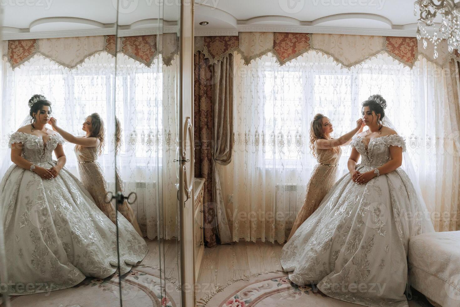 A woman in a wedding dress is touching another woman's face. The two women are standing in front of a mirror photo