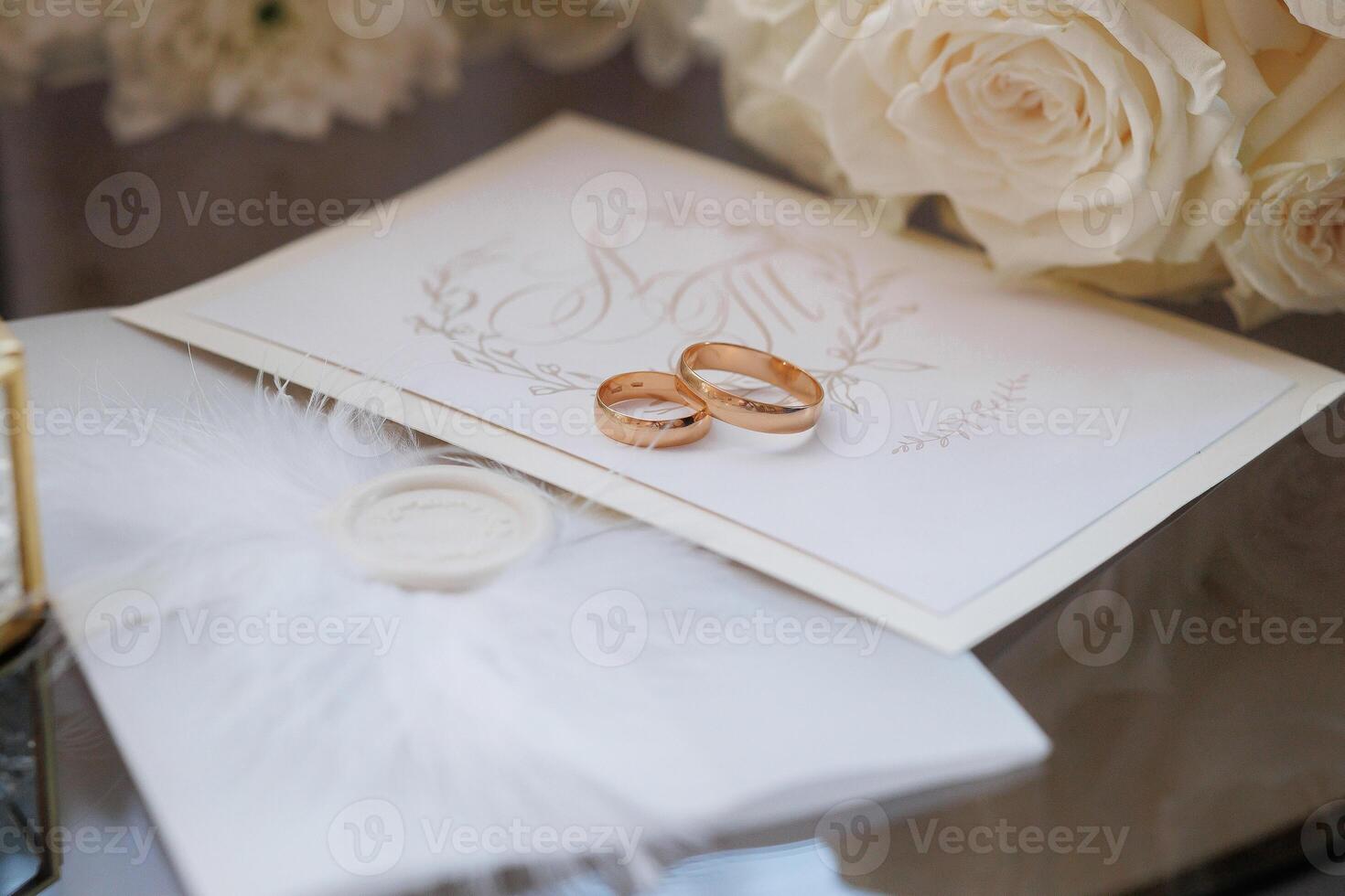 A white card with two gold rings on it photo