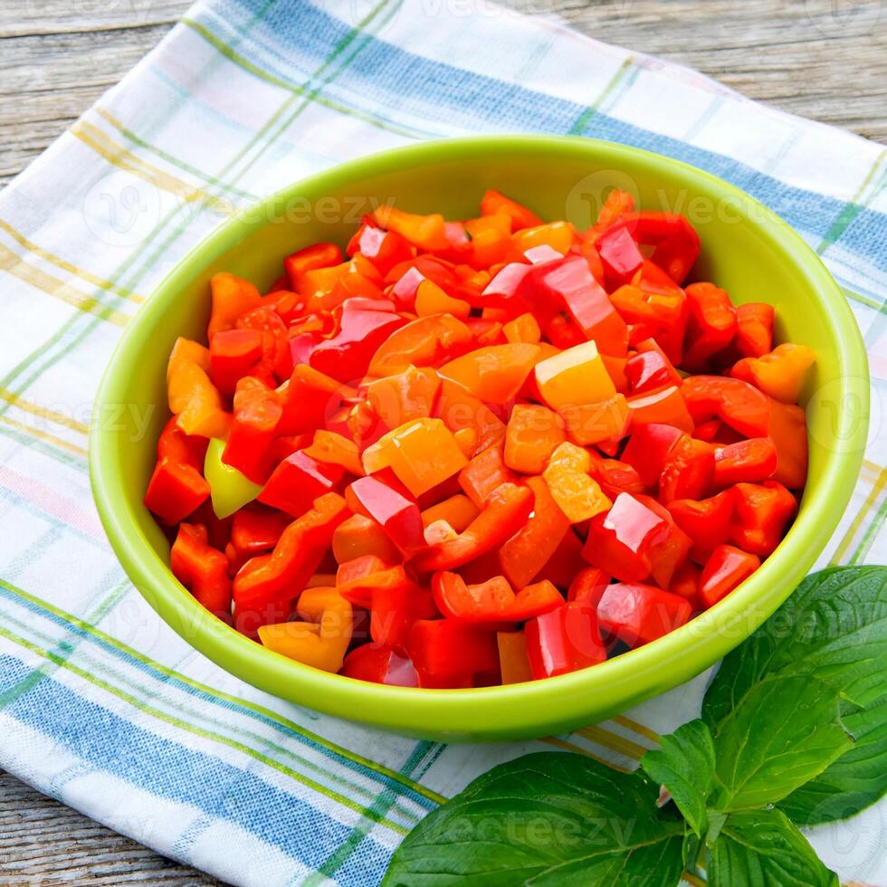 Tomatoes cut into small pieces in a delicious porcelain bowl photo