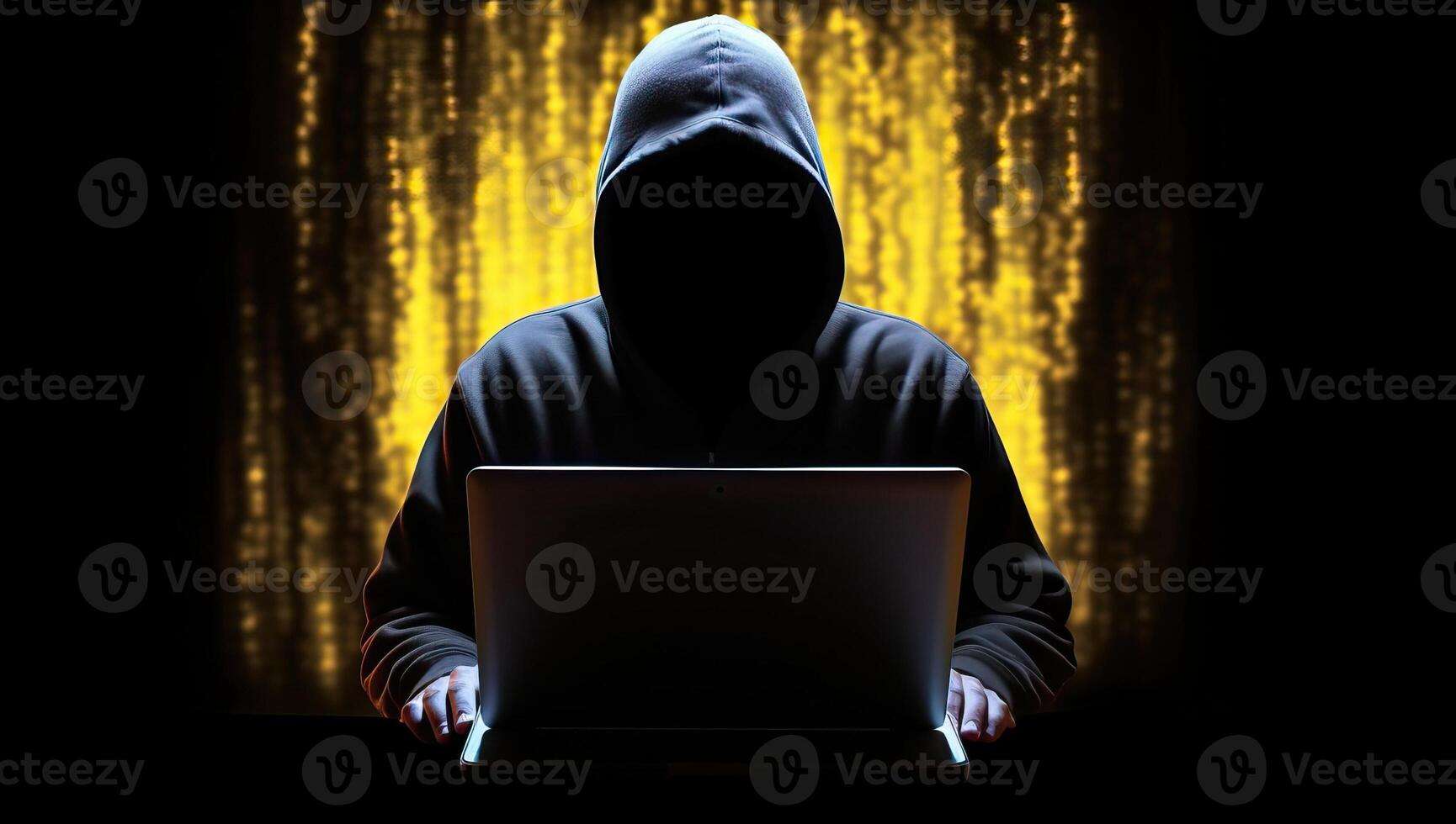 A hooded figure cloaked in shadow, illuminated by the eerie glow of a computer screen, embodying the dangers of the digital world. photo