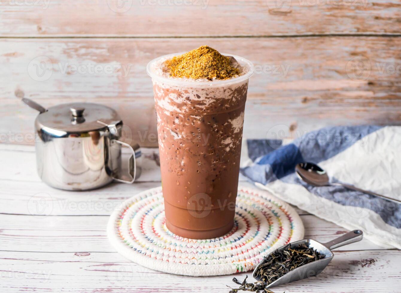 Iced Chocolate Wheat Germ Milk Tea with sugar pot and spoon served in disposable glass isolated on table side view of hong kong tea photo