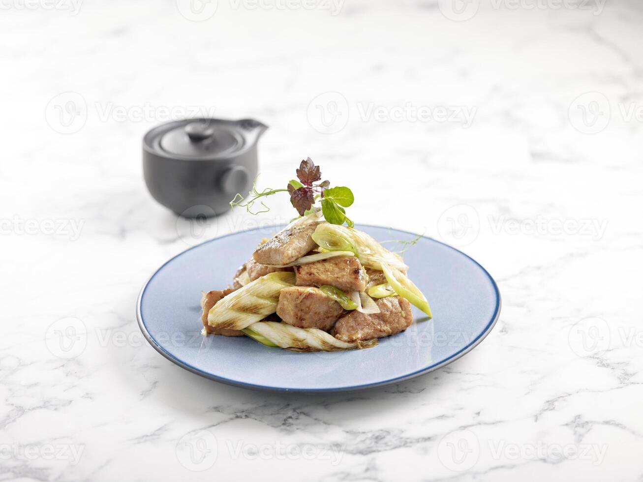 Pan fried Diced Kurobuta Pork with Japanese Sweet Sauce served in a dish side view on grey marble background photo