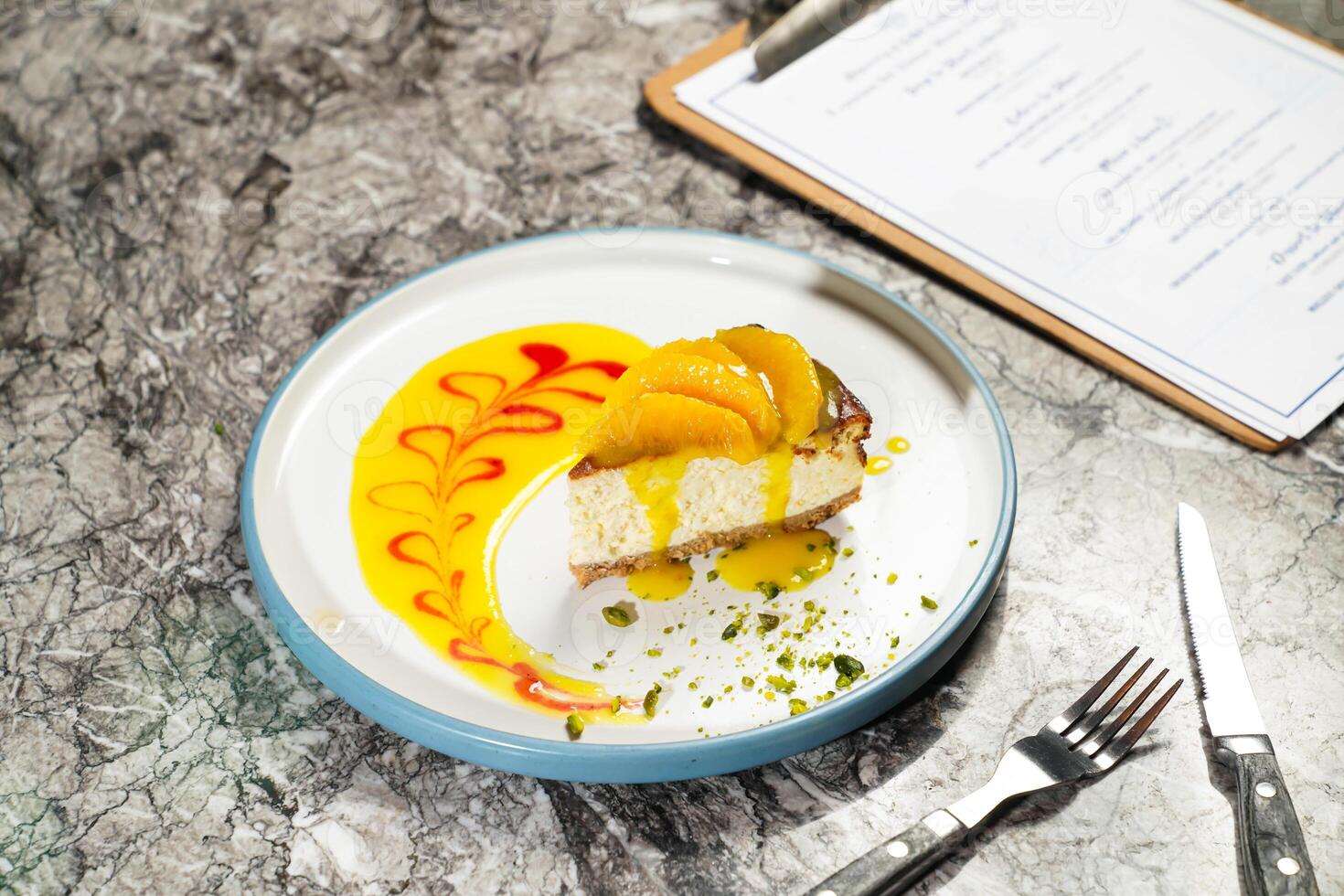 New York Cheesecake with Mandarin, fork and knife served in plate isolated on marble background side view of hong kong dessert cafe baked food photo