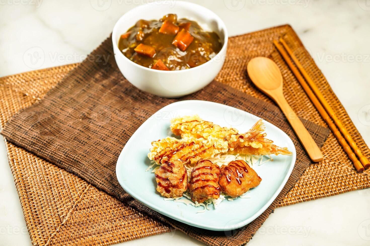 Japanese Deep Fried Chicken and Deep Fried Shrimp Curry Rice with chopsticks and spoon served in bowl isolated on napkin side view of Japanese food photo