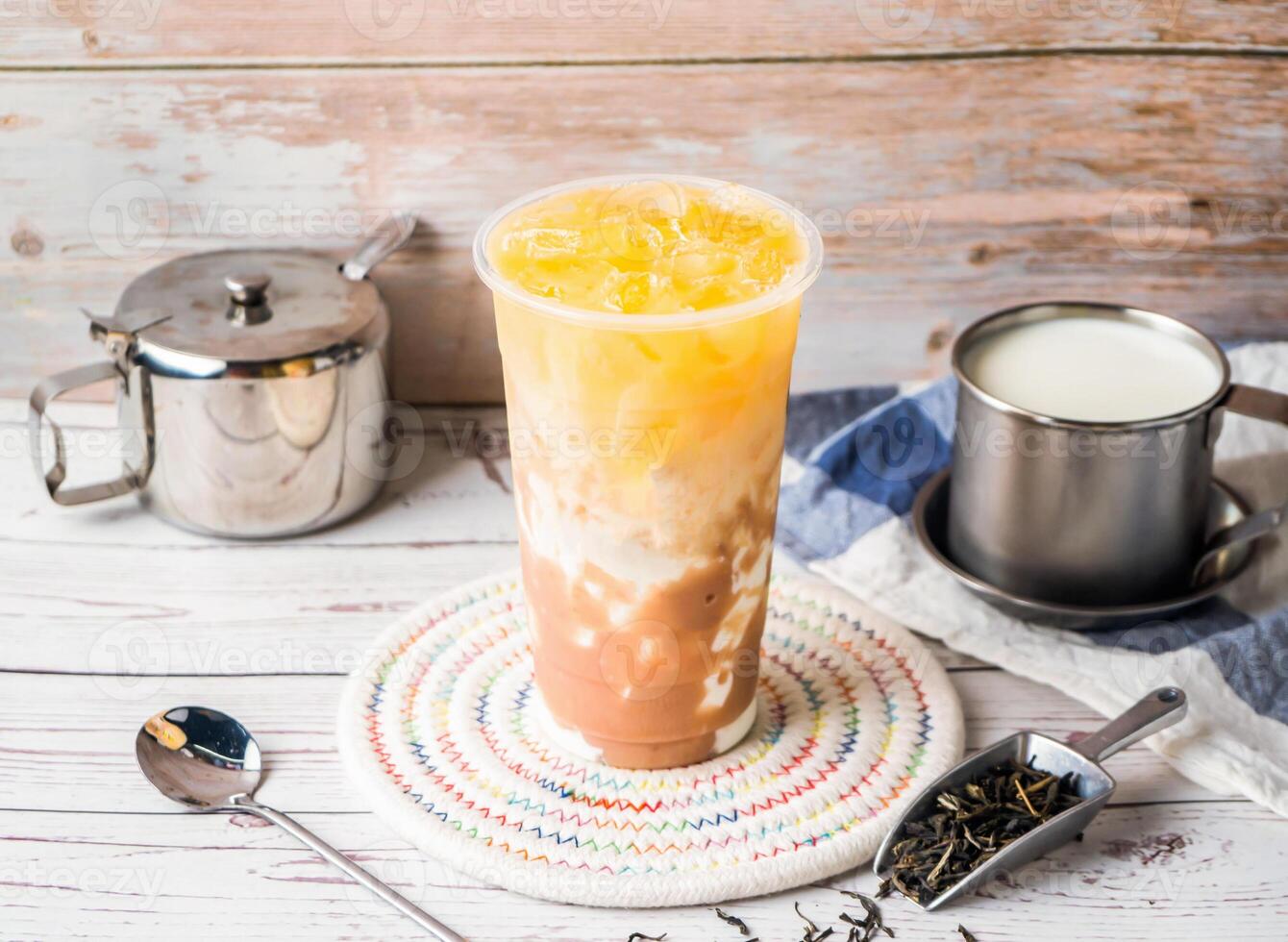 iced Taro Green Tea with Fresh Milk with sugar pot and spoon served in disposable glass isolated on table side view of hong kong tea photo
