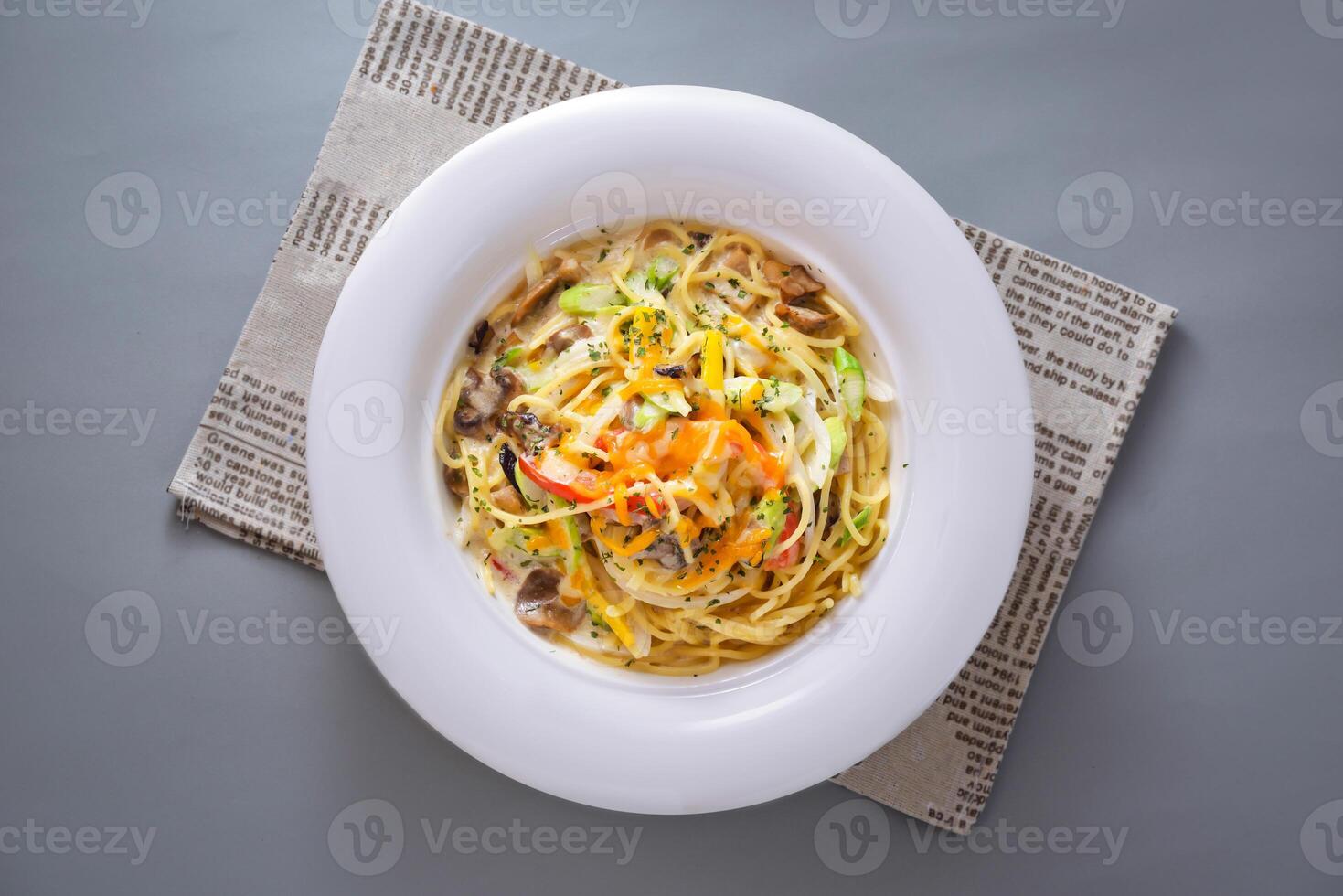 Carbonara Spaghetti served in dish isolated on napkin top view of chinese food on grey background photo