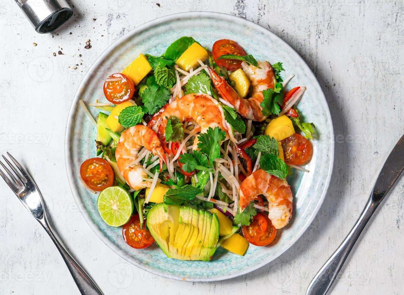 Prawn and Avocado Salad with cherry tomato, orange, lemon, mint, coriander, and onion served in plate isolated on background top view of italian food photo