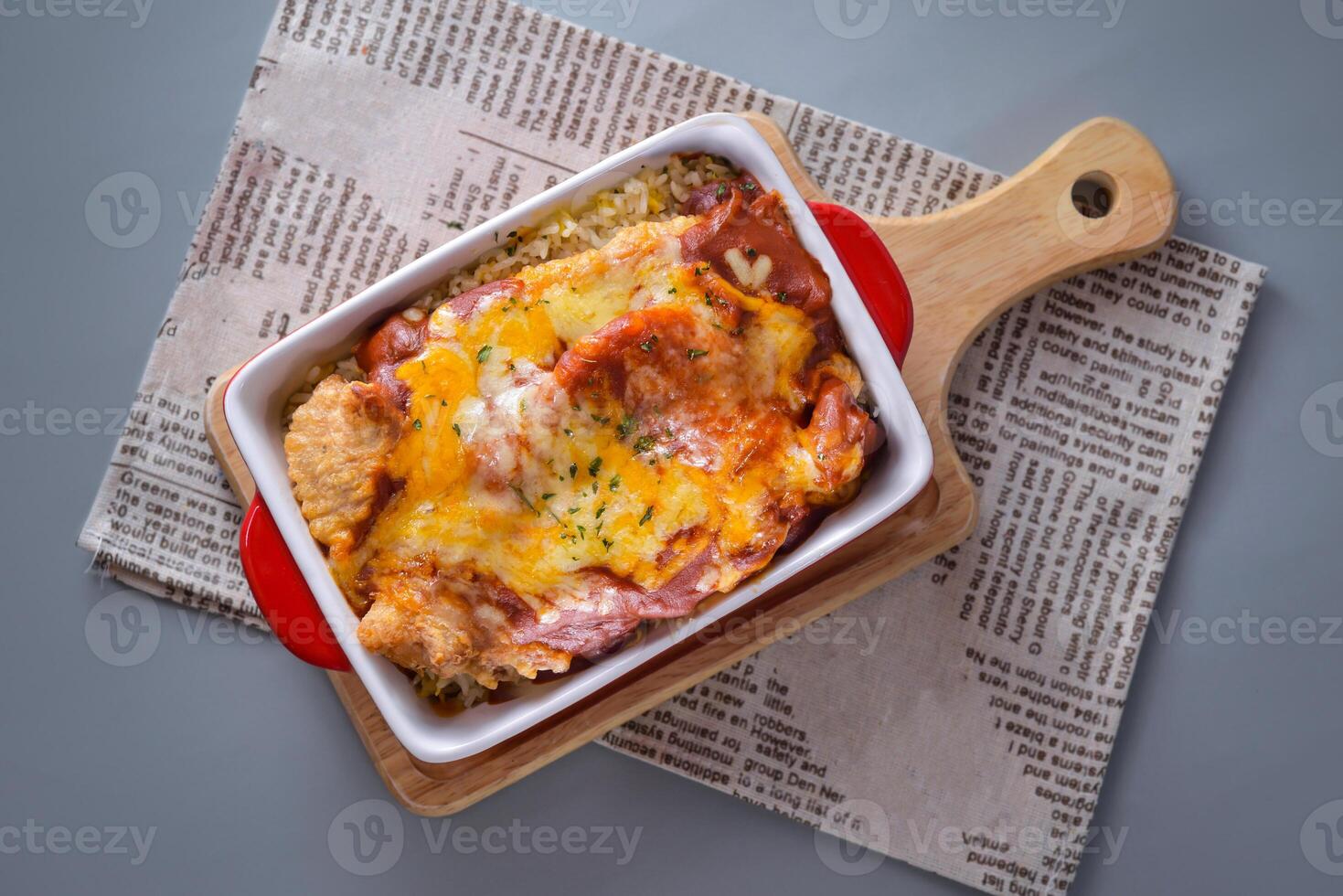 Baked Pork Chop Rice with Tomato Sauce served in dish isolated on napkin top view of chinese food on grey background photo