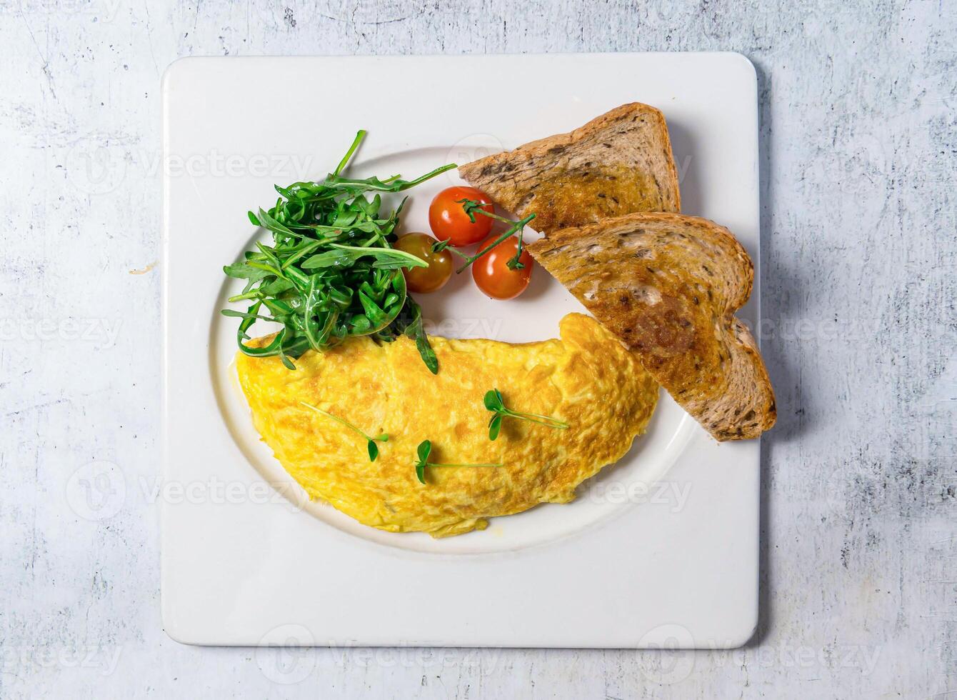 Omelette with brown bread served in plate isolated on background top view of italian food photo