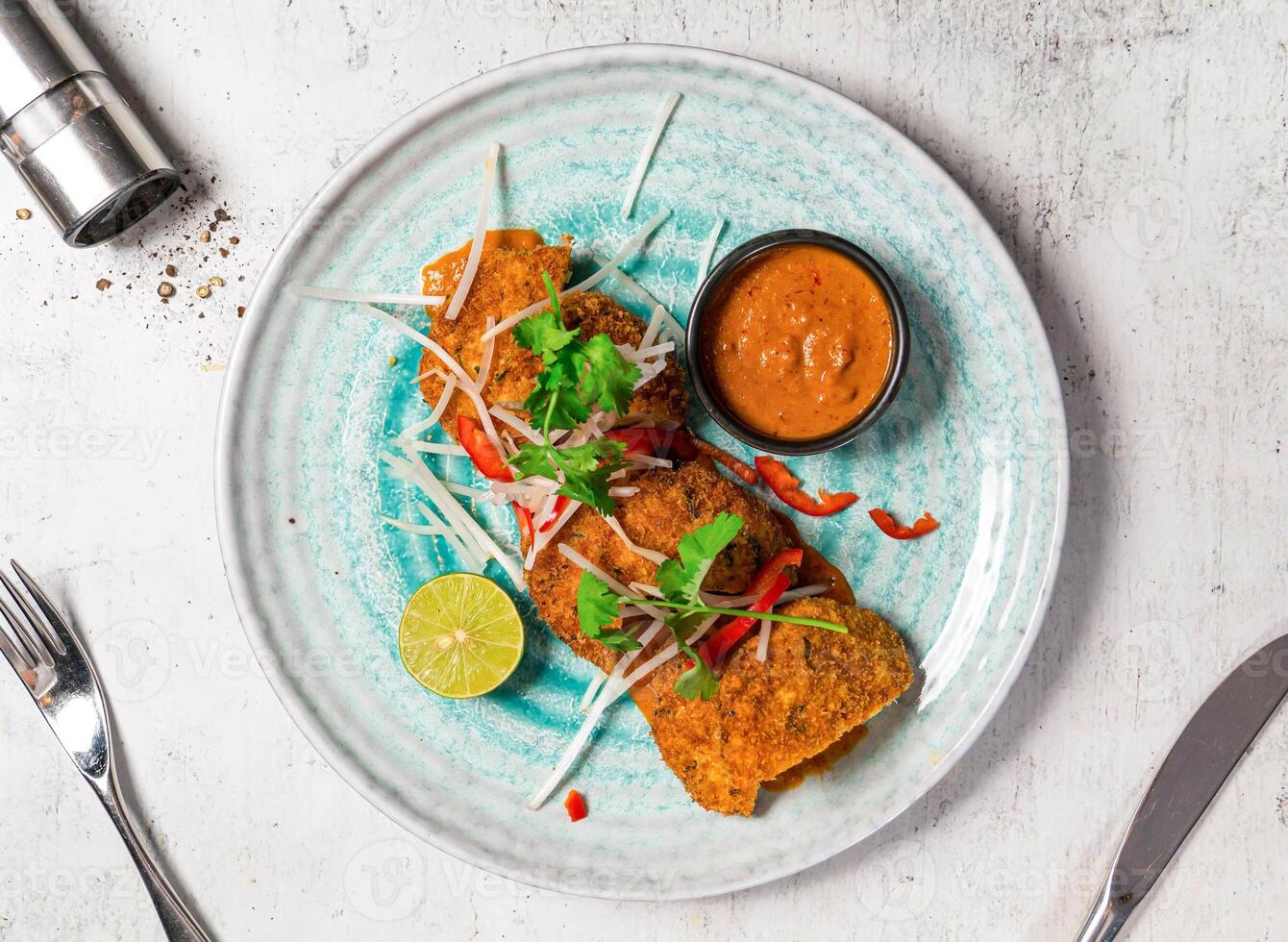 Crab Cakes with Thai Red Curry Sauce served in plate isolated on background top view of italian food photo
