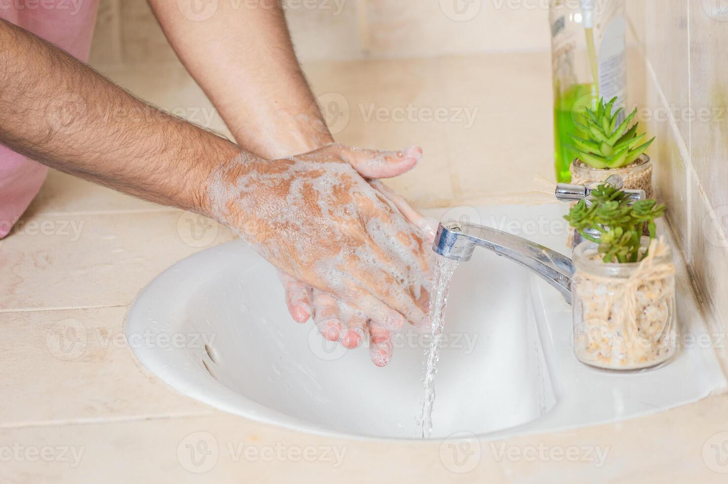 Close up of a man washing their hands with soap, concept of correct hand washing, ways to prevent covid19 photo