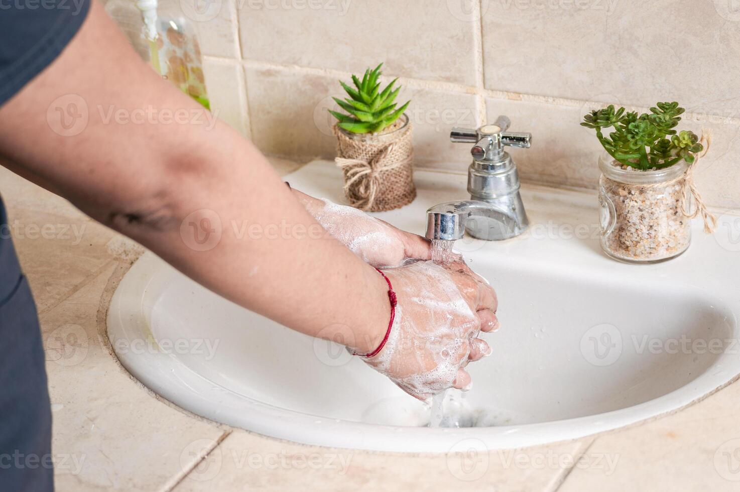 Close up of a person washing their hands with soap, concept of correct hand washing, ways to prevent covid19 photo
