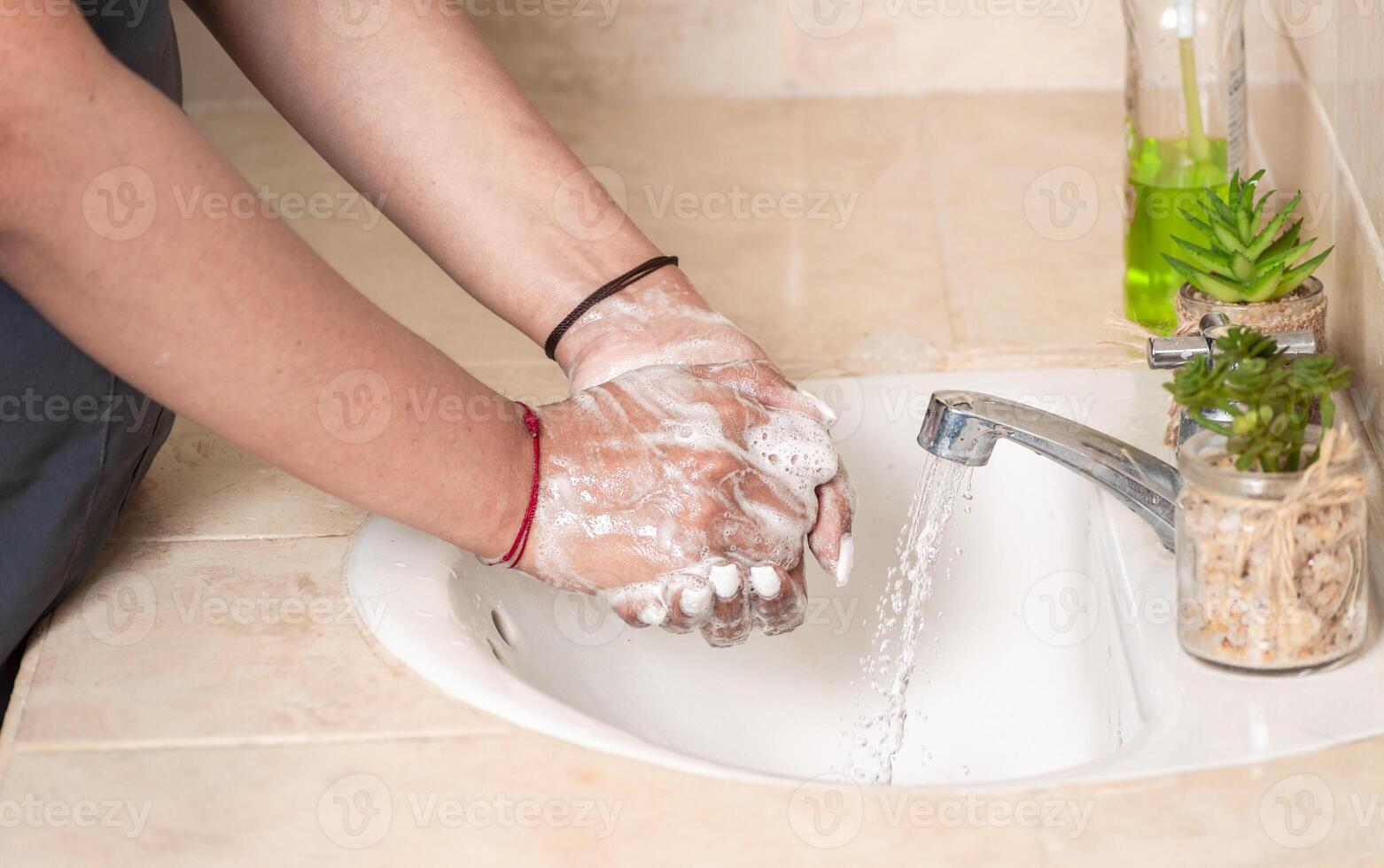 Close up of a person washing their hands with soap, concept of correct hand washing, ways to prevent covid19 photo