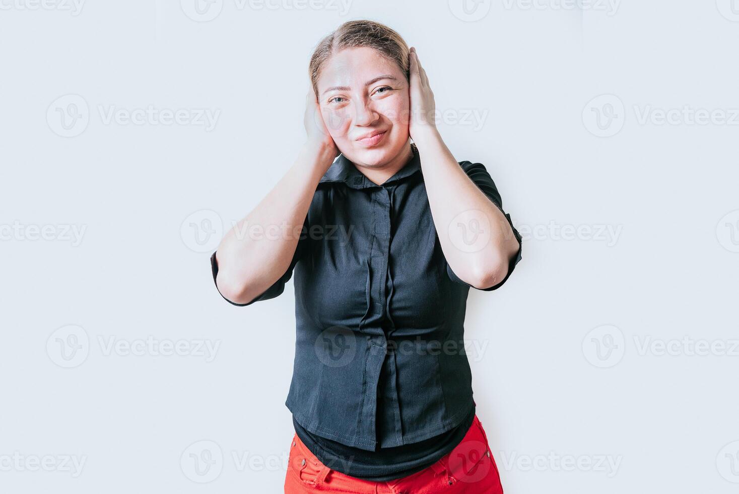 Displeased girl in glasses covering her ears isolated. Frustrated woman covering her ears tightly photo