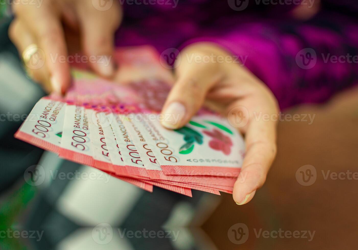 People counting Nicaraguan 500 cordobas banknotes. Hands of woman counting banknotes photo