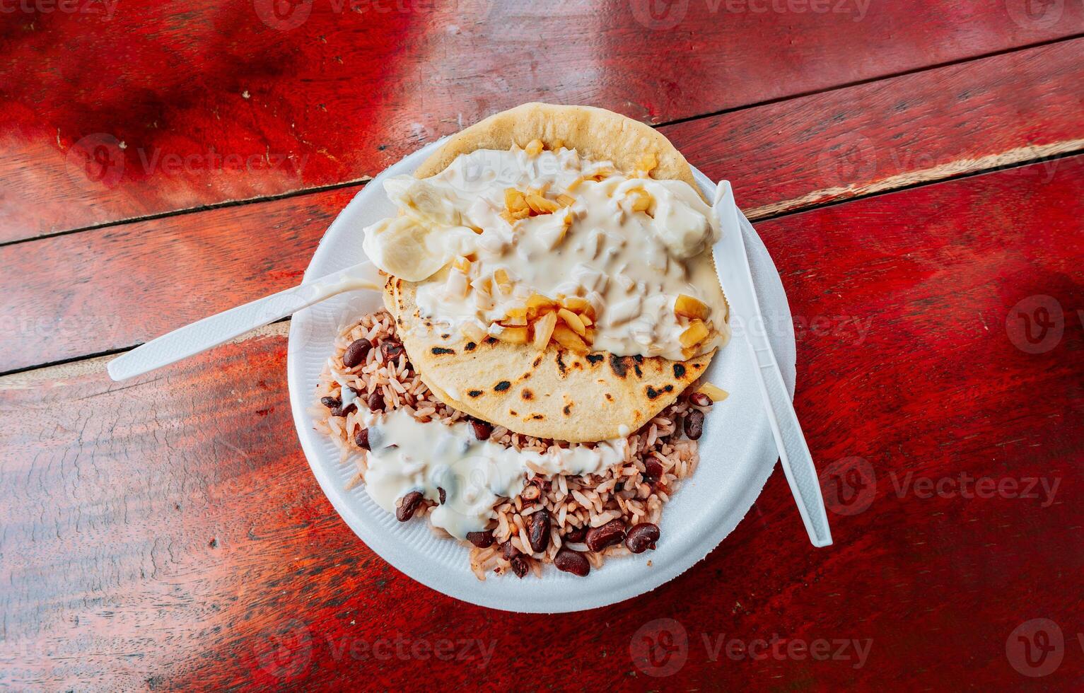 Gallopinto with Quesillo served on wooden table. Top view of traditional Gallopinto with quesillo on the table. typical nicaraguan foods photo