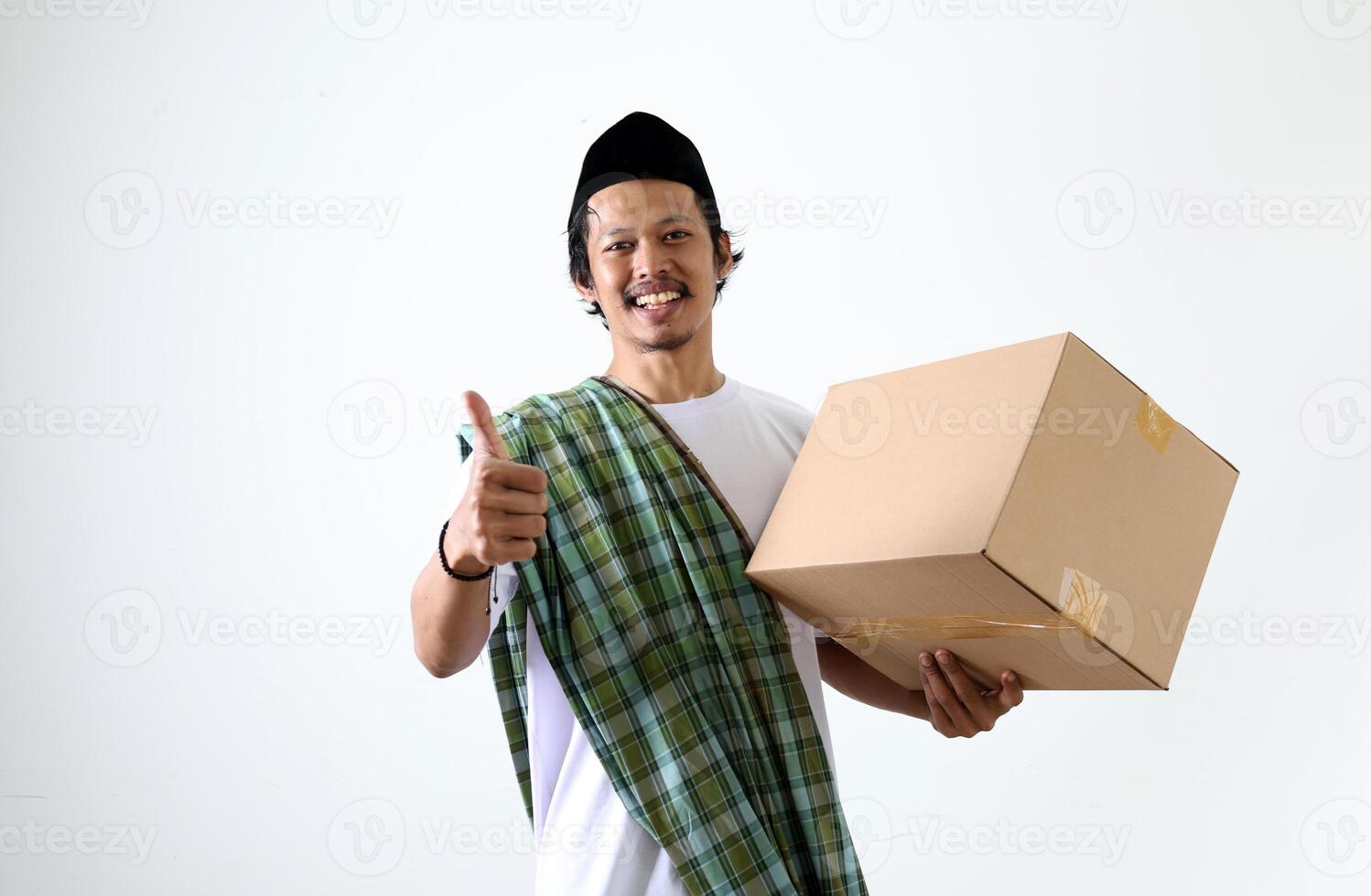 Happy Asian Muslim with Sarung and Kopyah, Holding Card Box and Thumbs Up photo