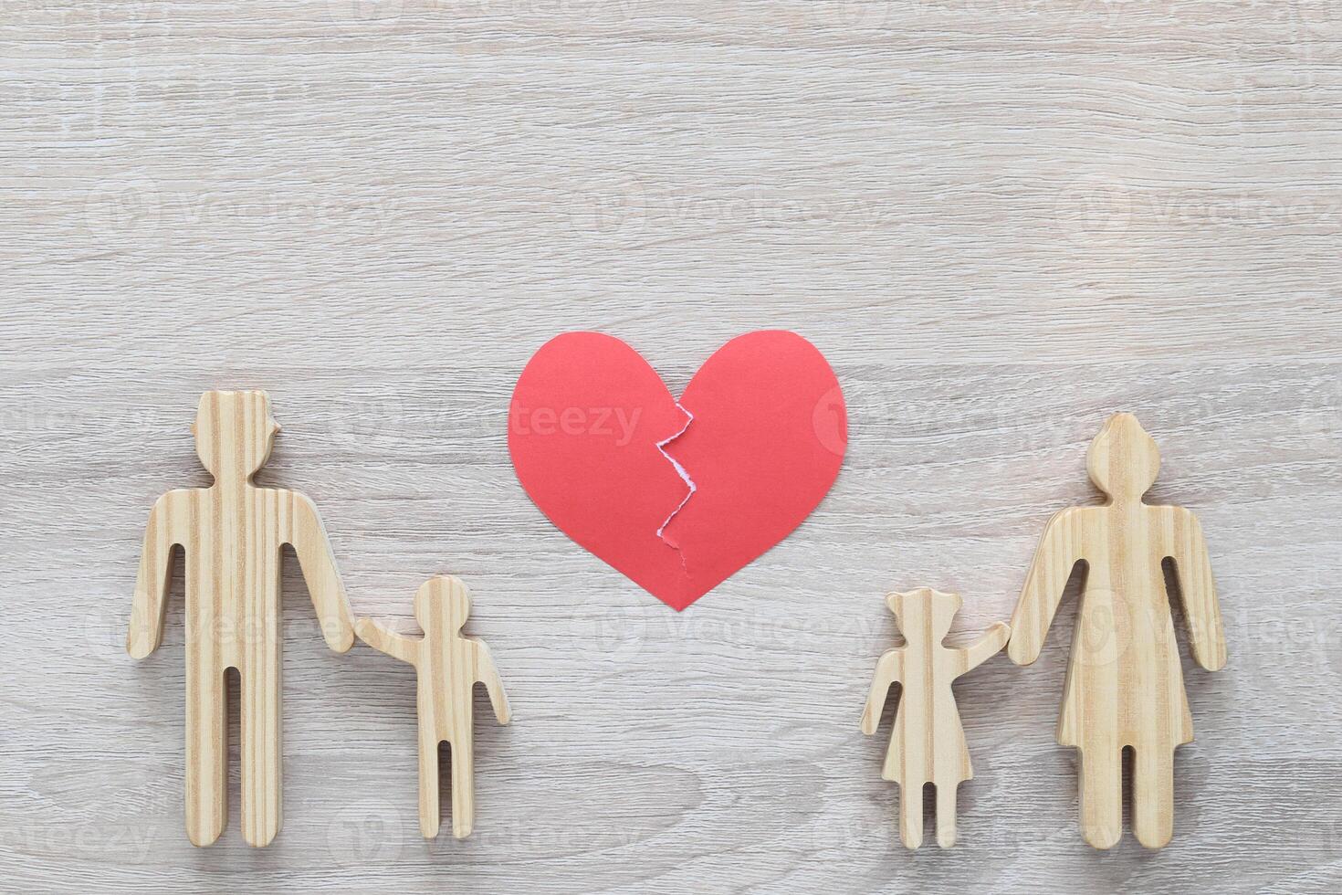 Divorce lawyer Or Attorney, Broken red heart with husband and wife splitting children on wooden background,Joint child custody and alimony concept. photo