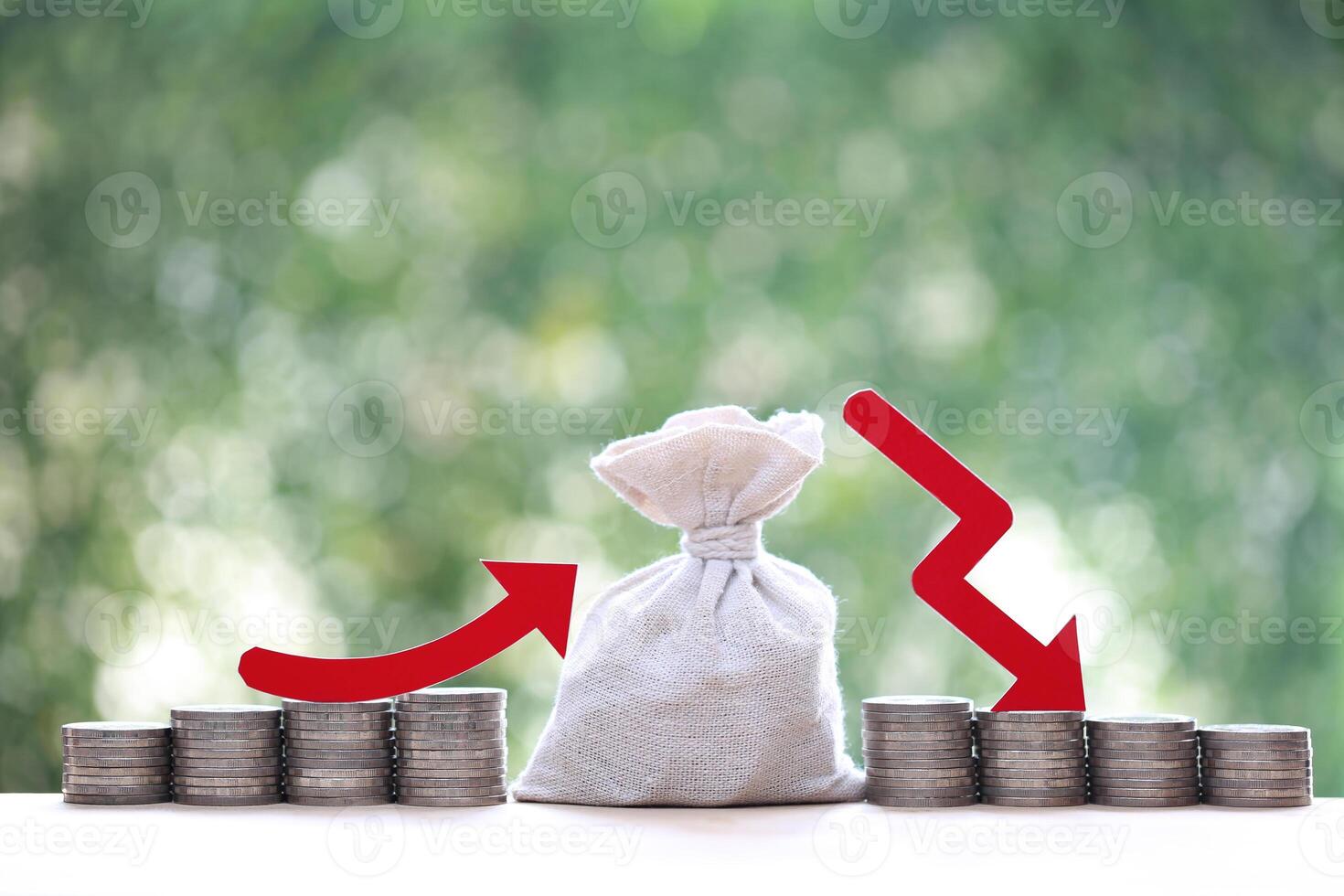 Funding,Red arrow on stack of coins money and money bag with on natural green background, investment fund finance concept photo