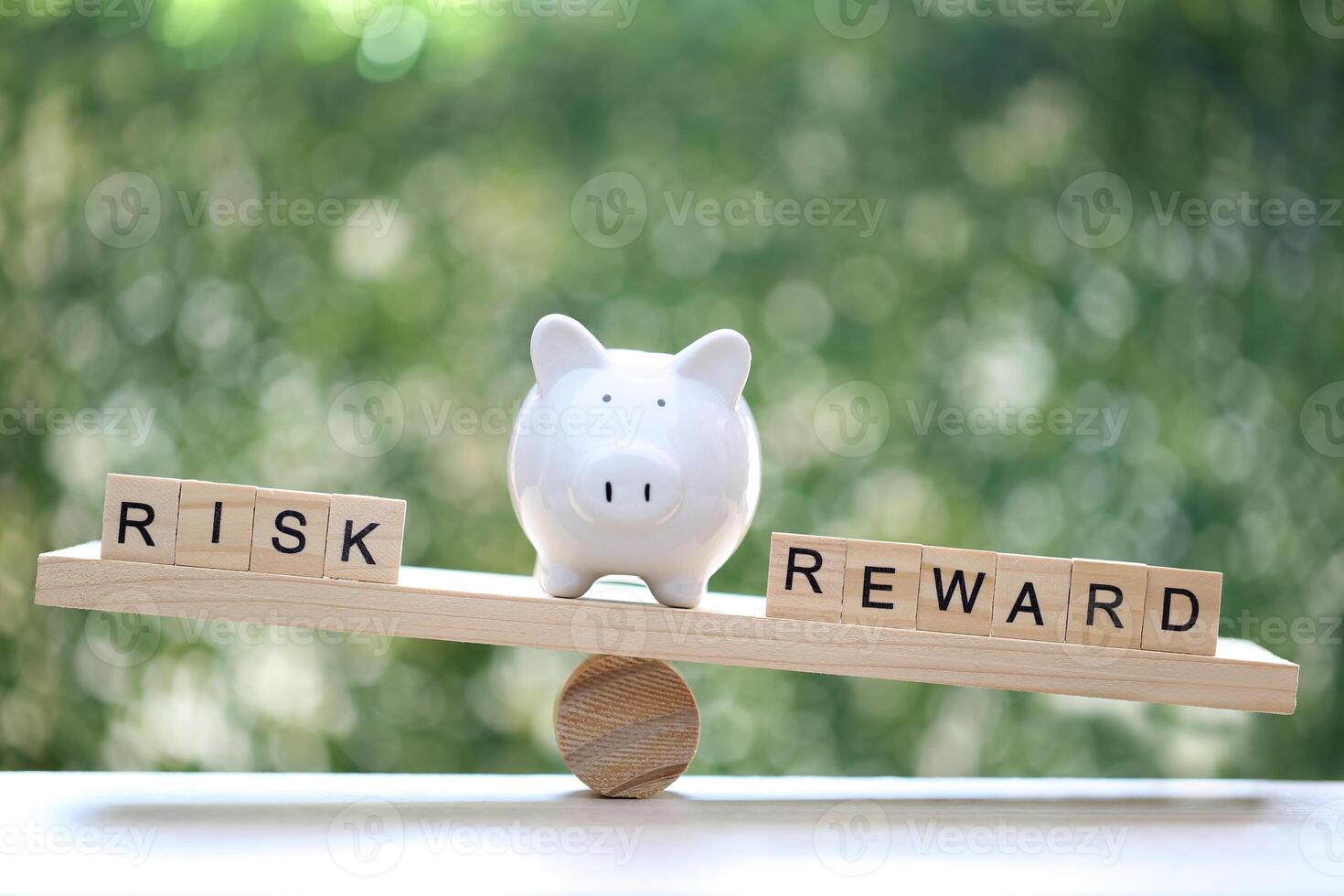 Wording risk and Reward on wood block on natural green background, Business investment and Risk management concept.Financial risk assessment photo