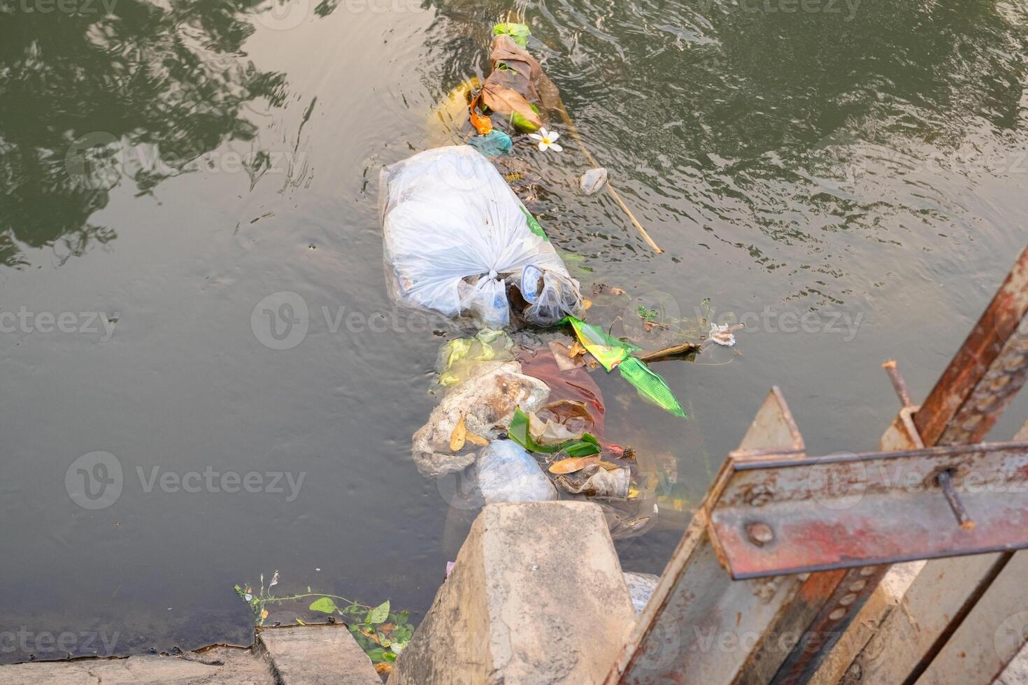 Trash floating in the water photo