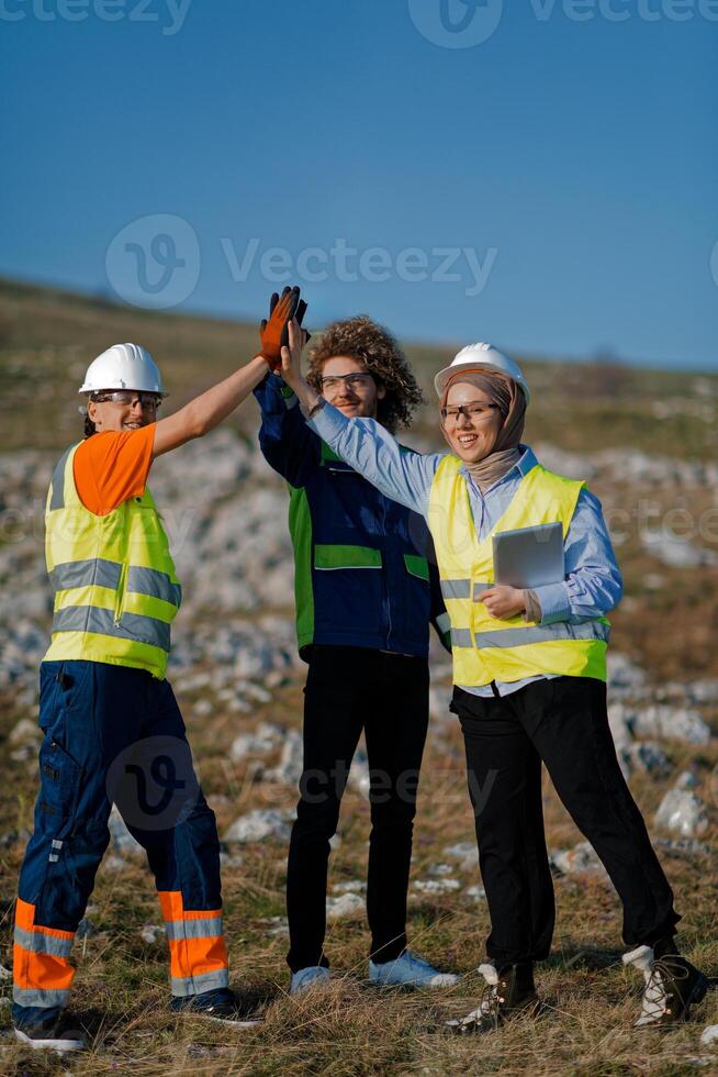 Engineers Collaborating in the Field to Inspect and Optimize Electric Turbines. photo