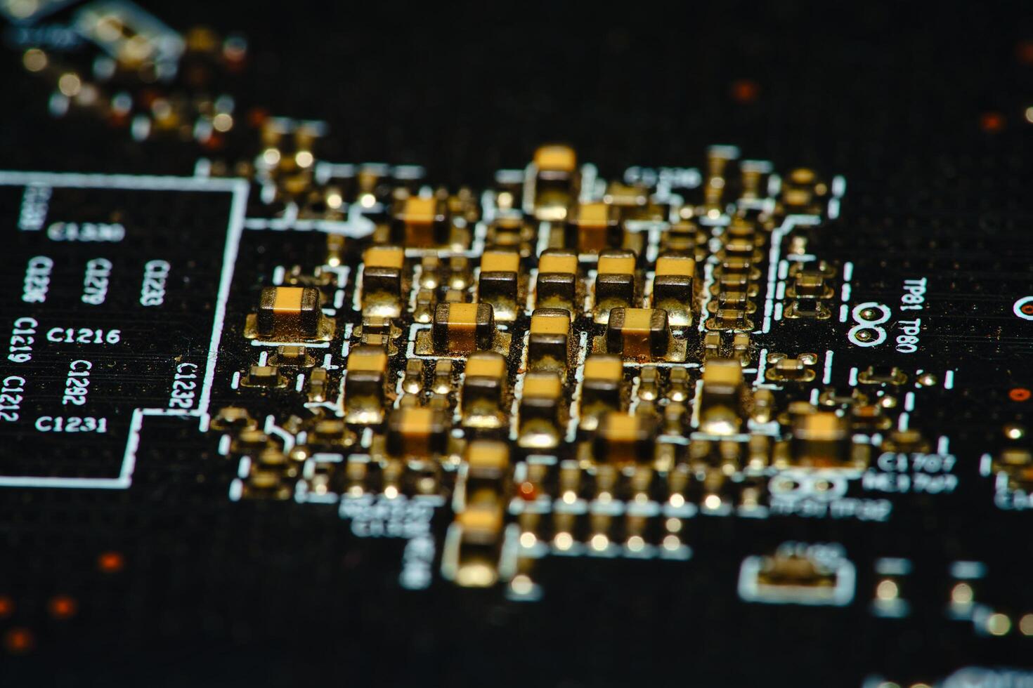 close up of a circuit board with gold and black components photo