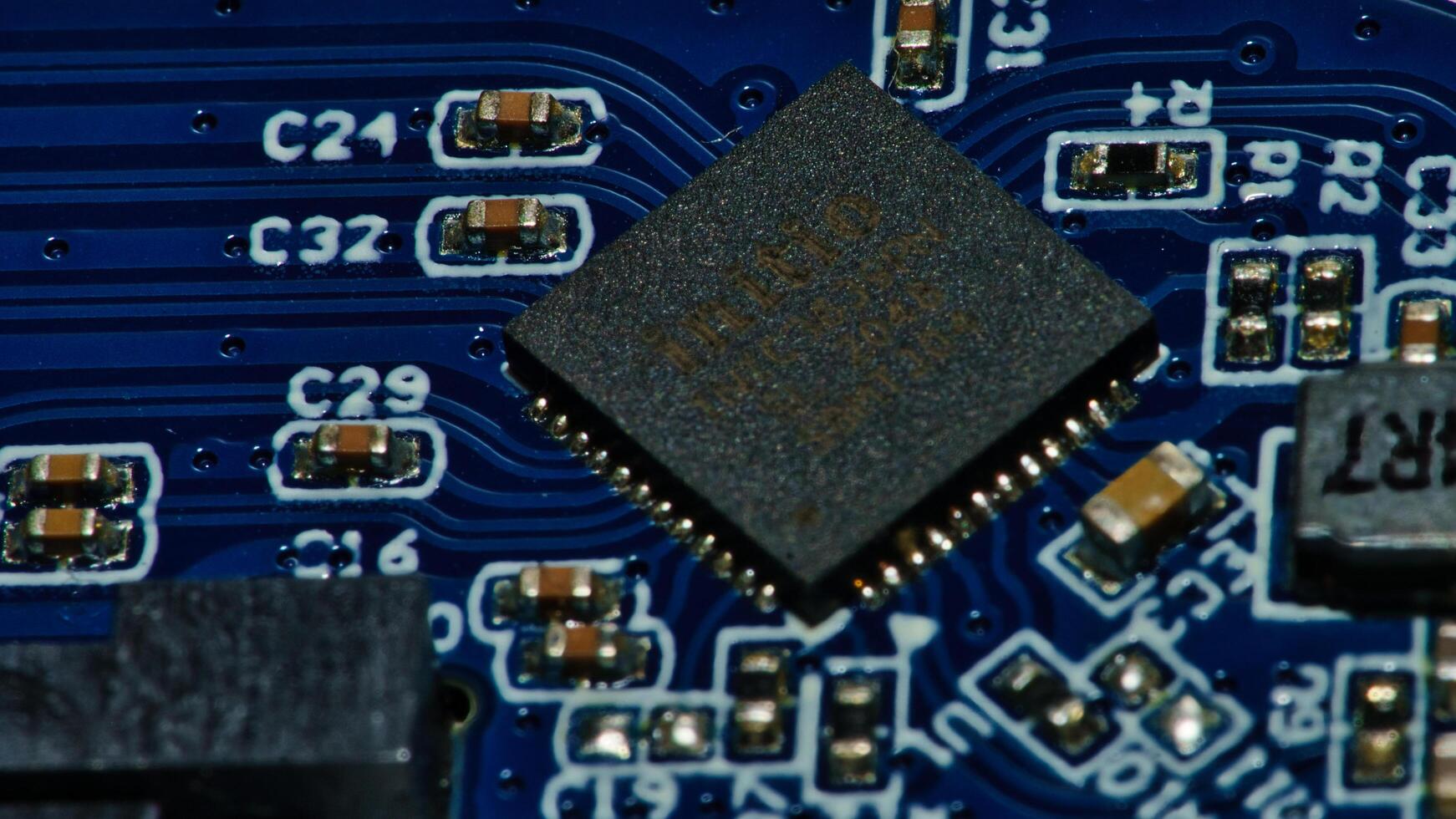a close up of a microchip on a blue circuit board photo