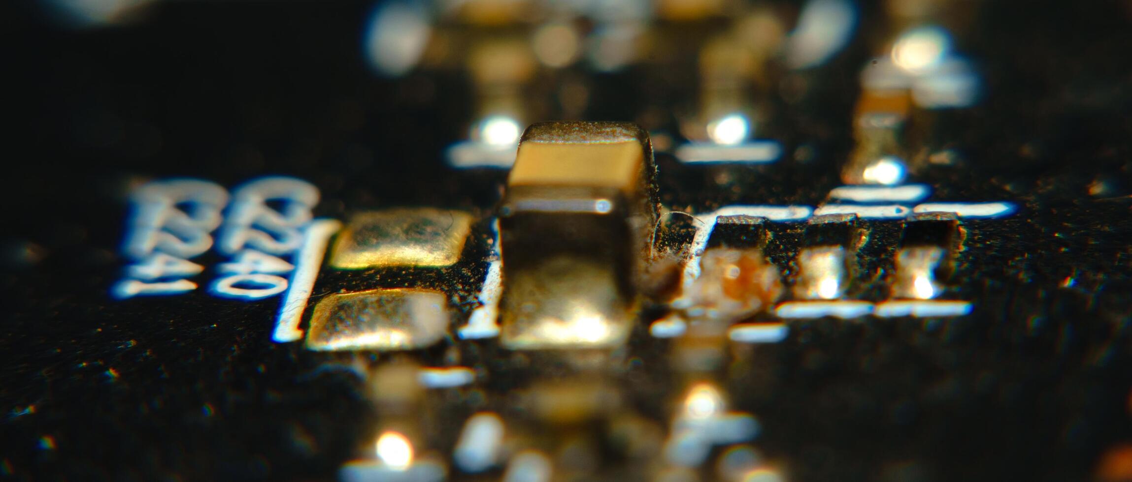 close up of a circuit board with a gold and black color photo