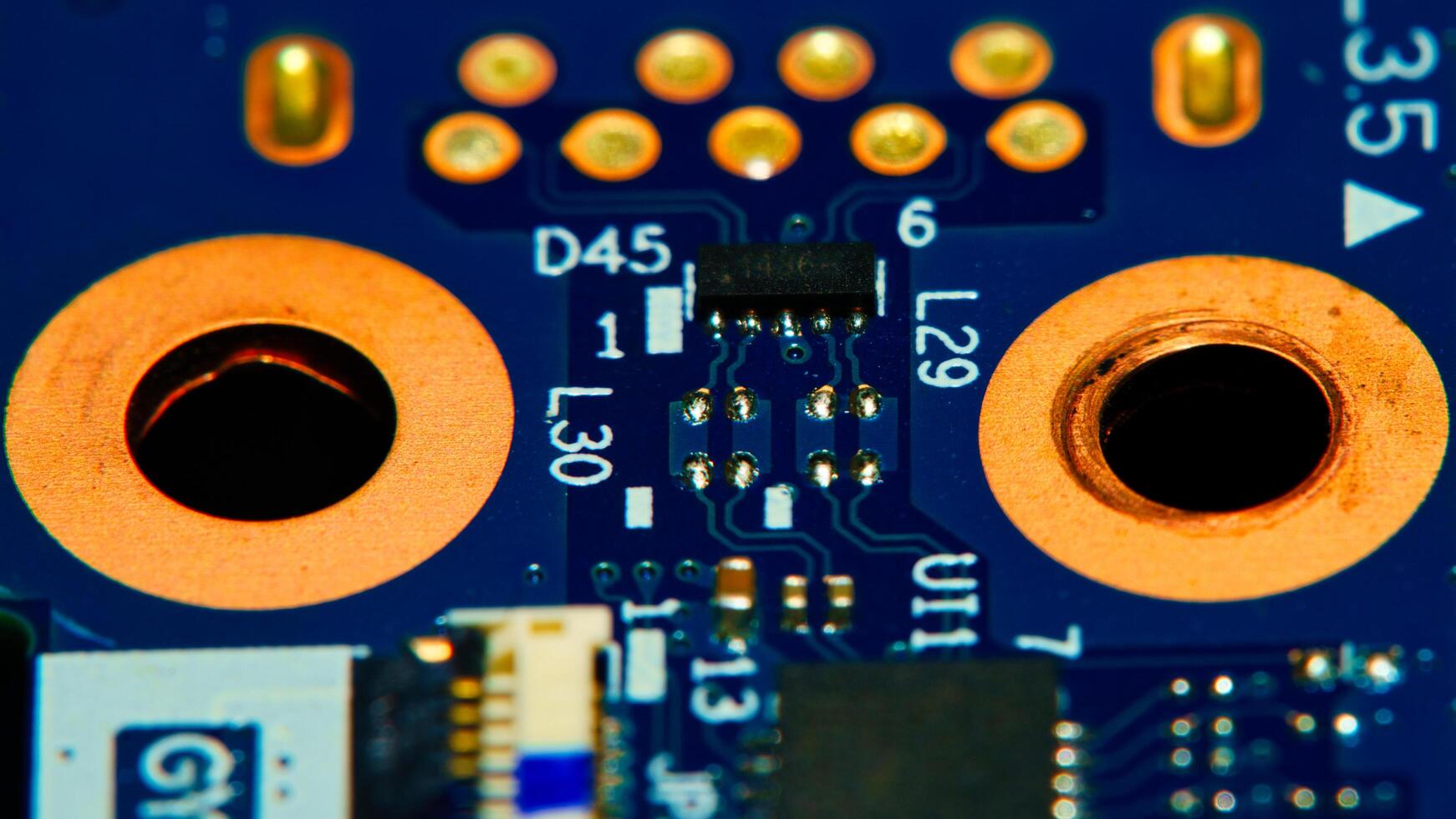 a close up of a computer motherboard with a few holes photo