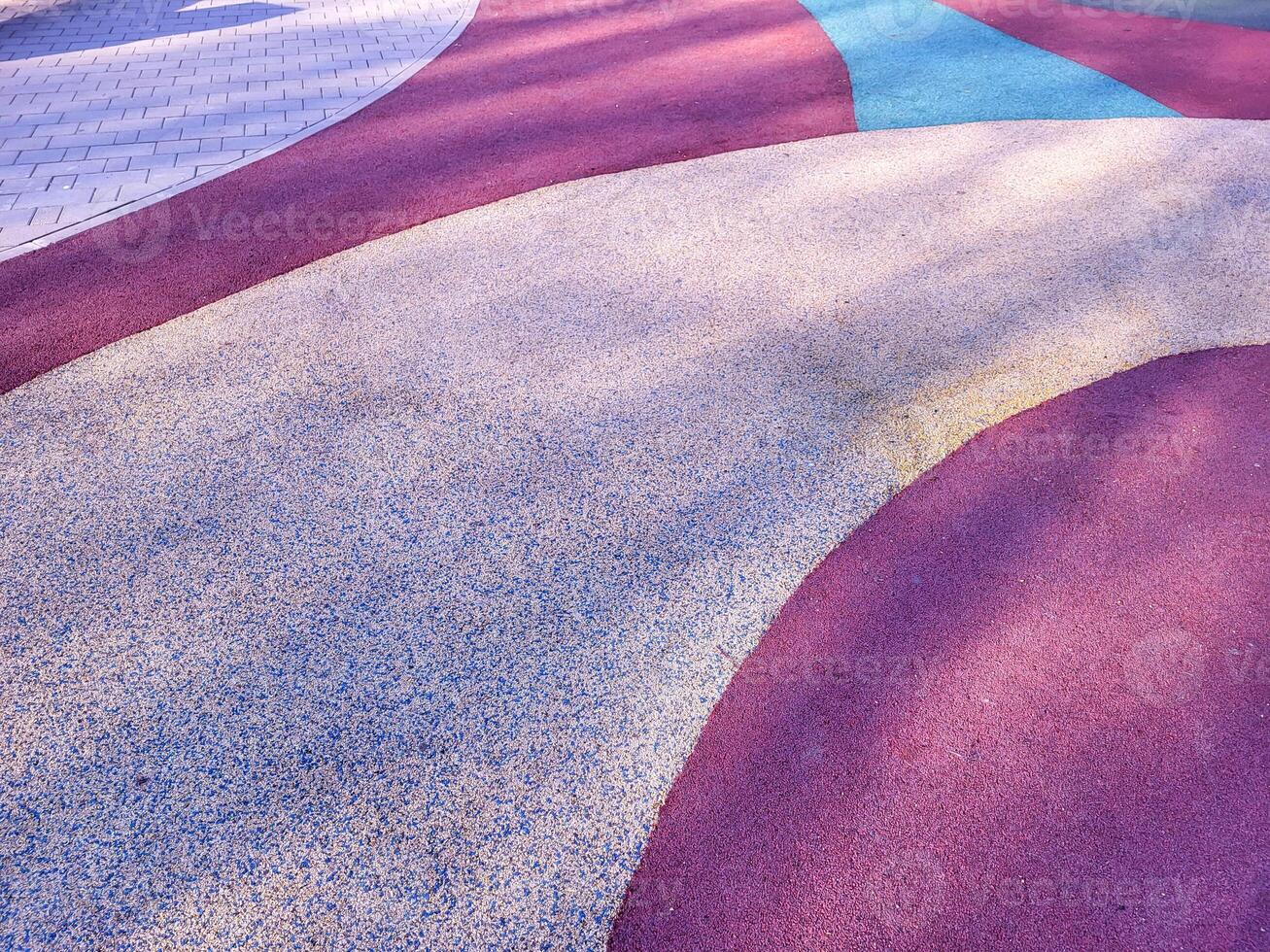 Colorful background of the rubber coating of the outdoor sports ground. View from above. photo