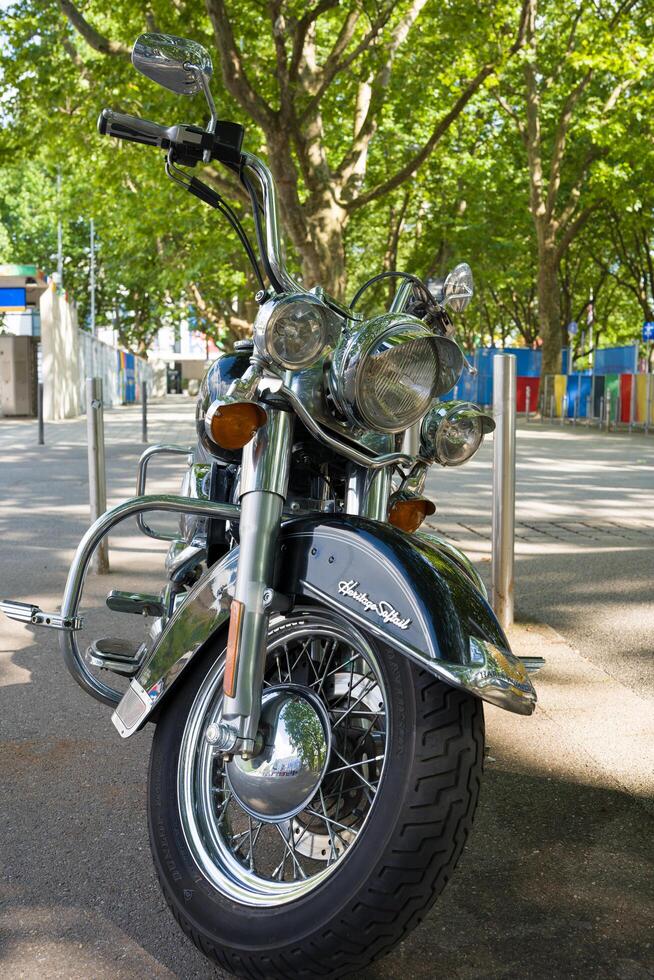 Stuttgart, Germany 14 July 2024. Harley Davidson motorcycle isolated on a white background. A black iconic motorcycle on the background of a city street. photo