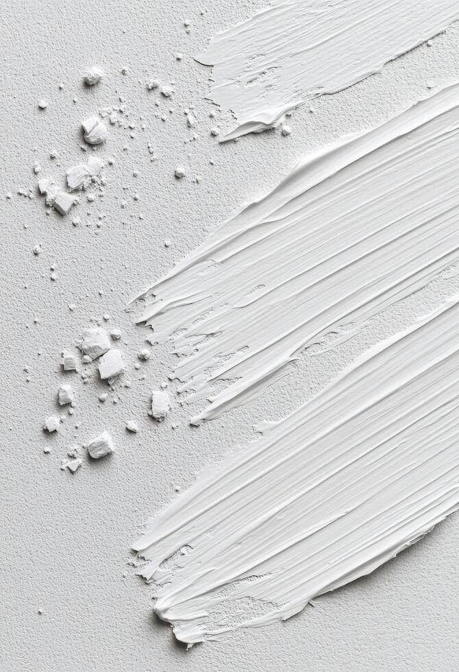 Layers of textured white paint on canvas creating a smooth artistic surface photo