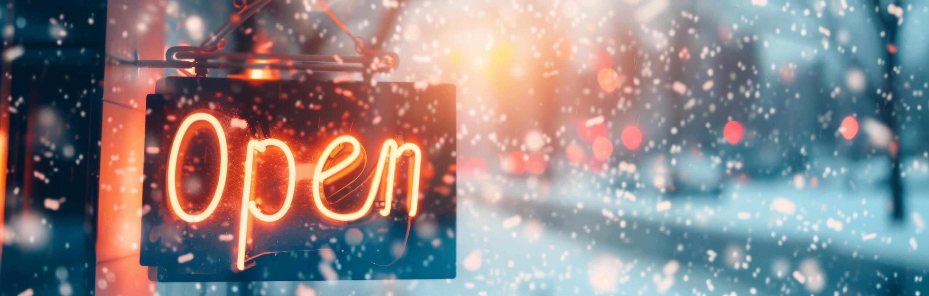 Open Sign Hanging in Snowy Urban Setting During Winter Evening photo