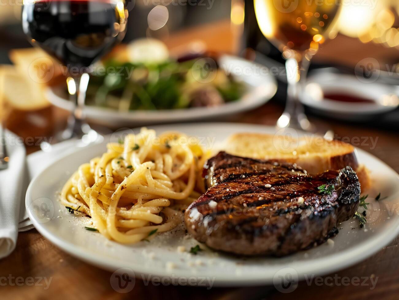 Grilled steak with pasta and garlic bread, paired with a glass of red wine, evokes a rich and indulgent dining experience photo